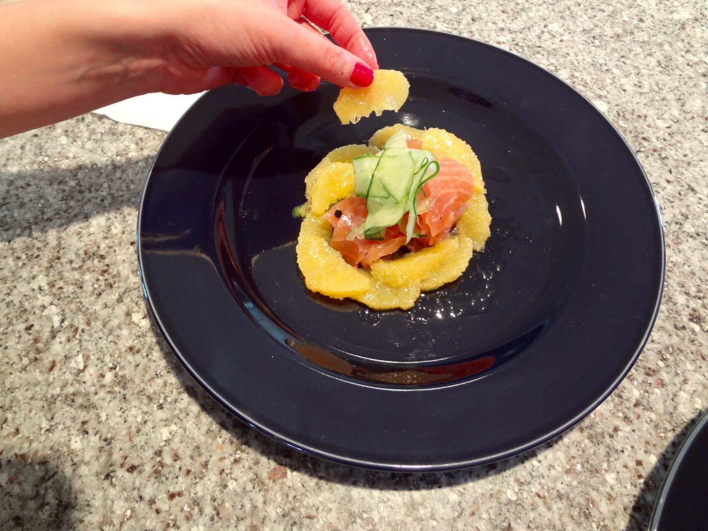 Adding oranges to the smoked salmon salad