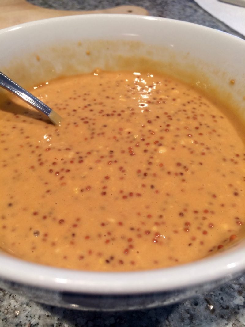 The maple glaze mixed in a bowl with a spoon.