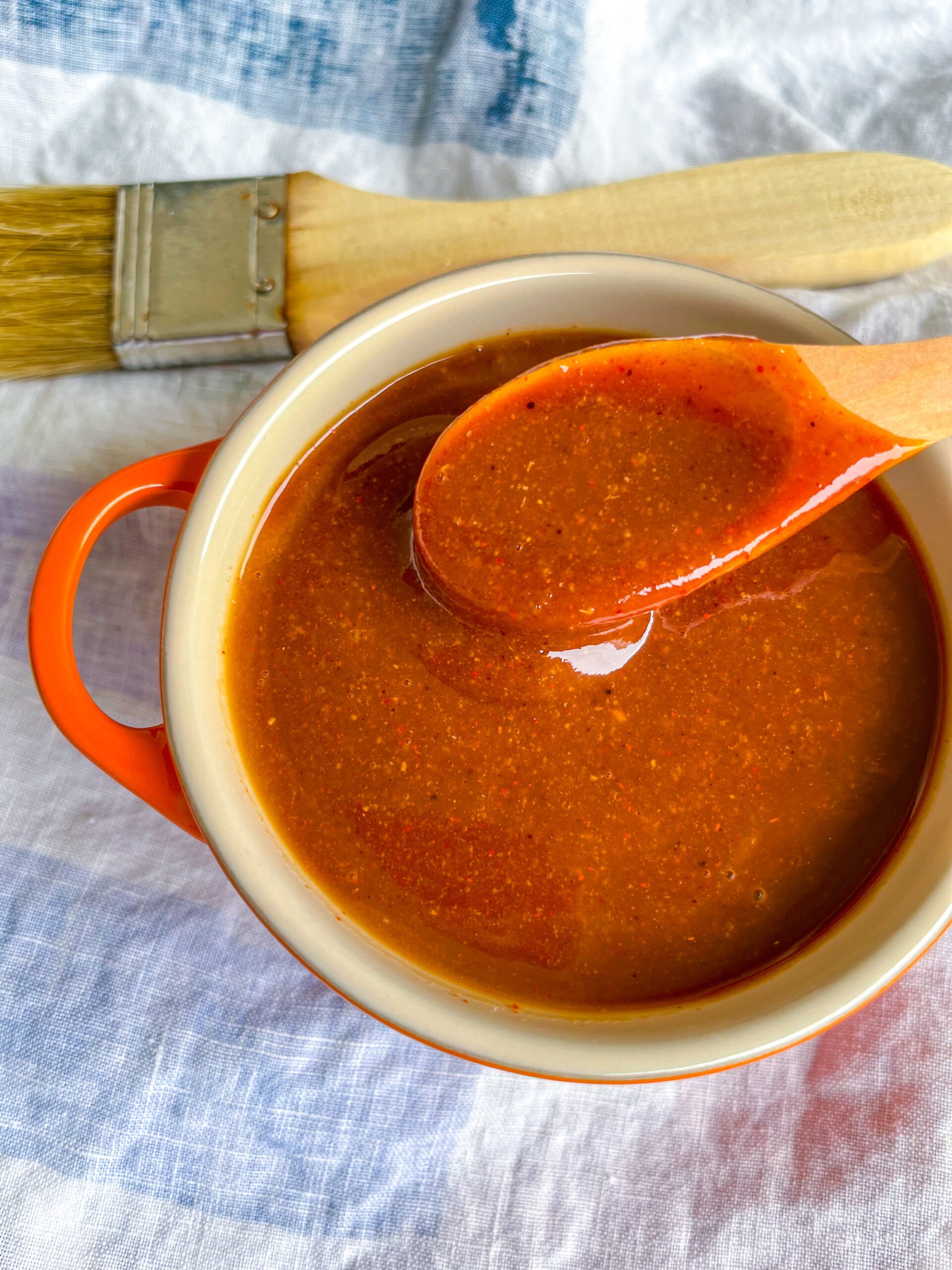 Close up of barbecue sauce in a bowl with a spoon