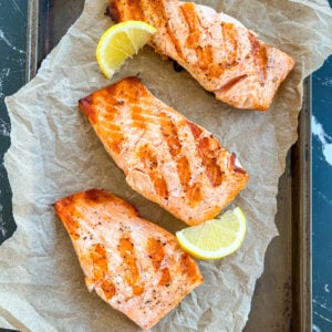 Grilled salmon fillets on parchment paper