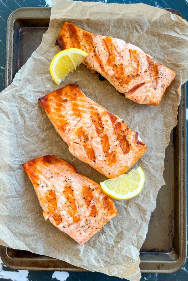 Grilled salmon fillets on parchment paper