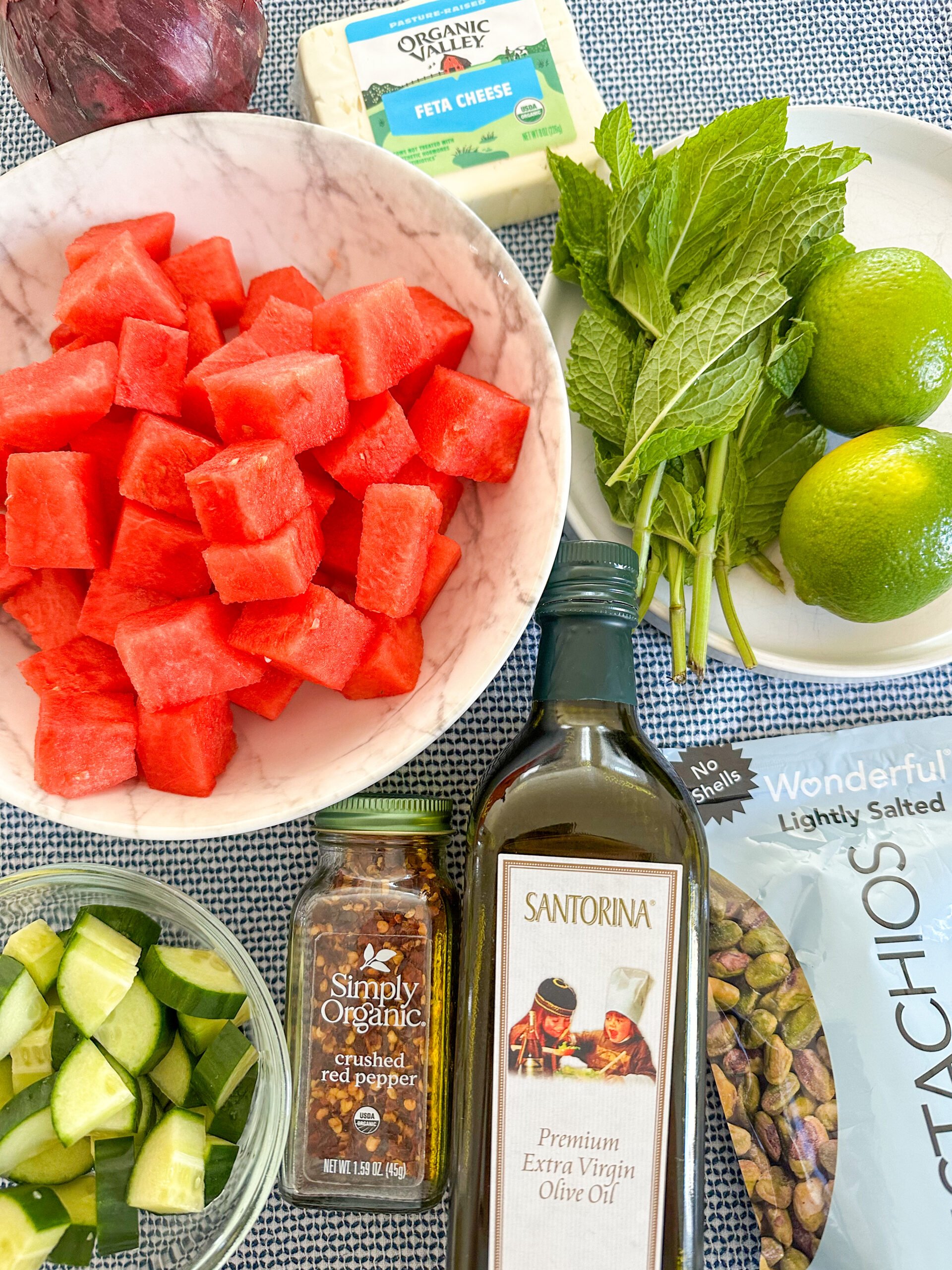 Watermelon feta salad recipe ingredients on a blue and white dish towel