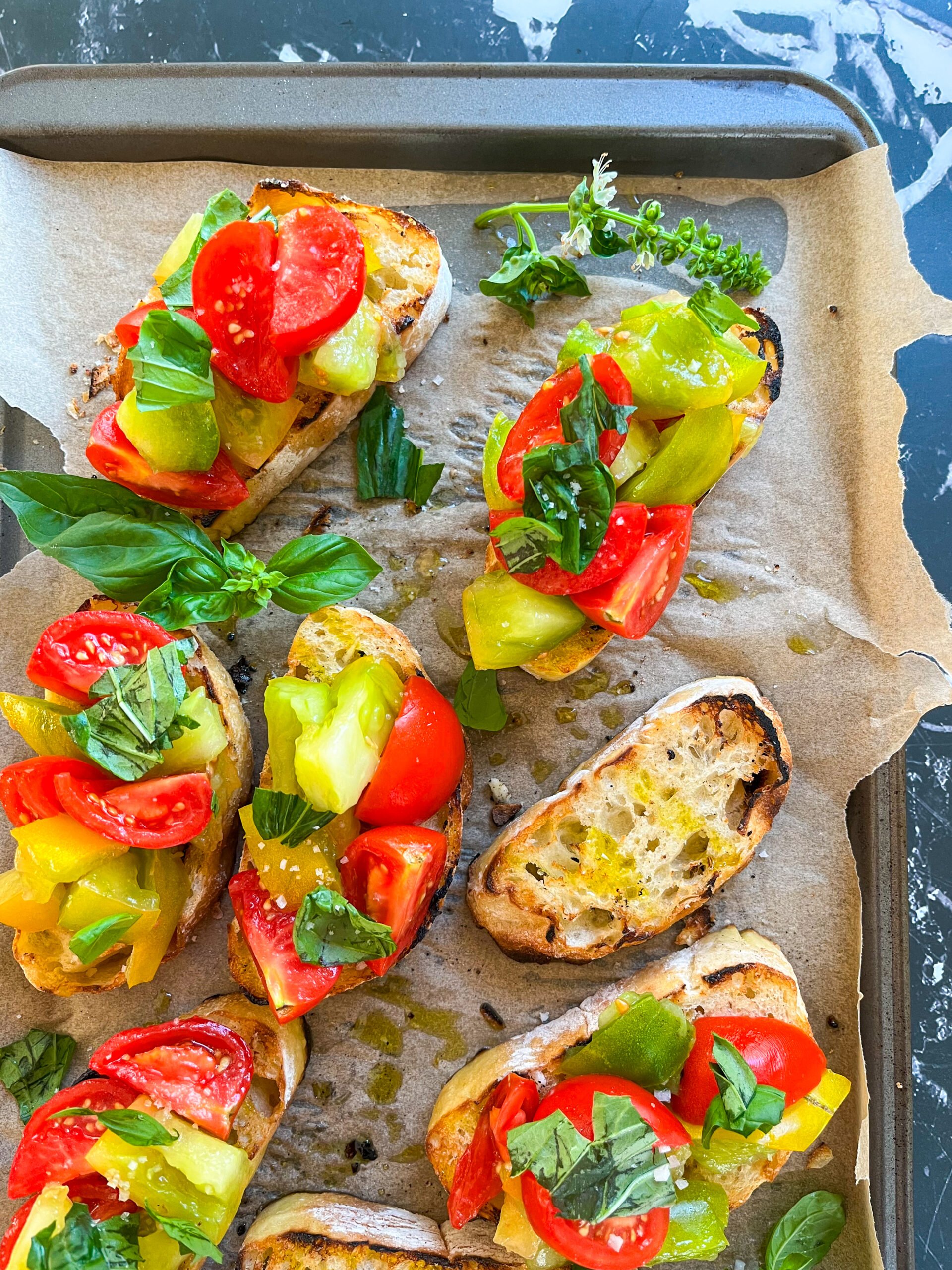 Bruschetta on a parchment lined sheet closer up
