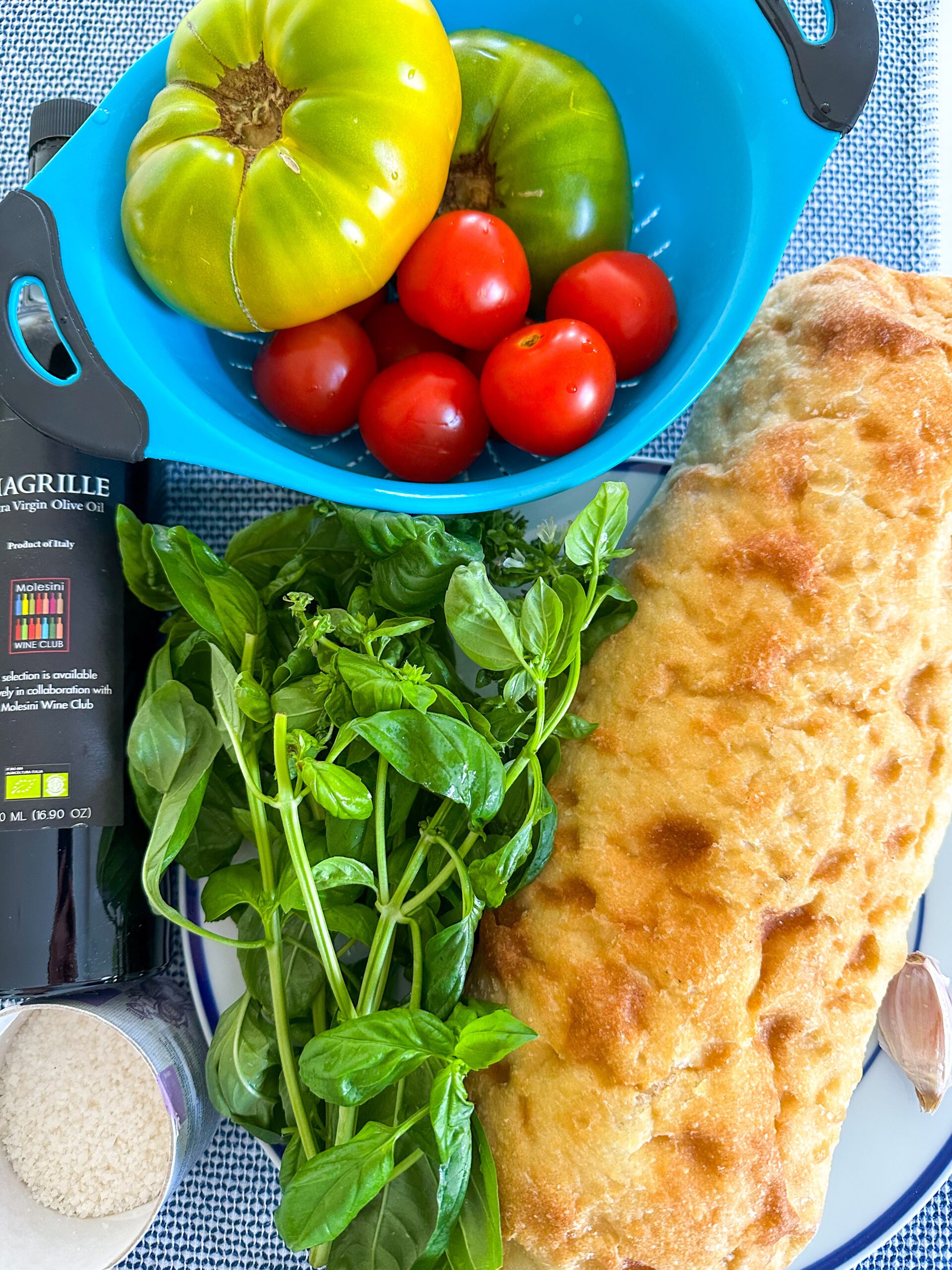Bruschetta recipe ingredients on a blue and white towel