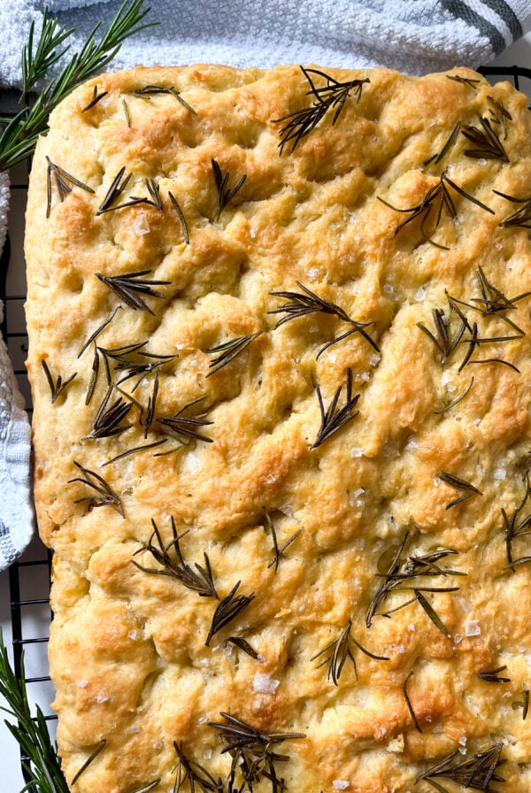Focaccia bread next to a white dish towel