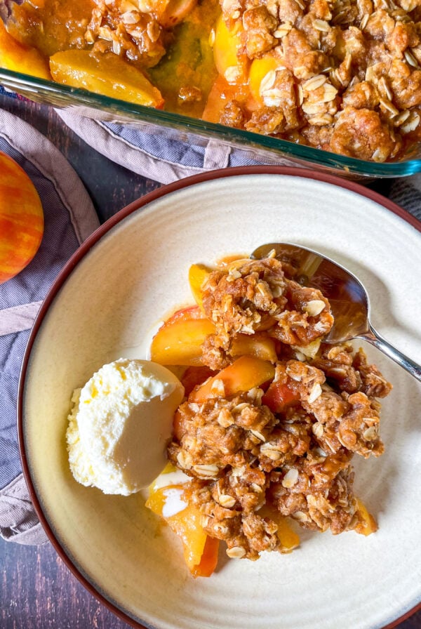 Apple crisp with a scoop of vanilla ice cream in a bowl