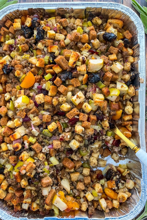 Sausage stuffing in a pan with a serving spoon