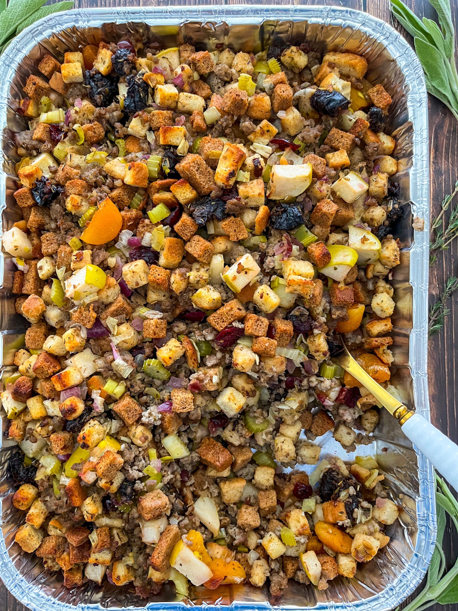 Sausage stuffing in a pan with a serving spoon
