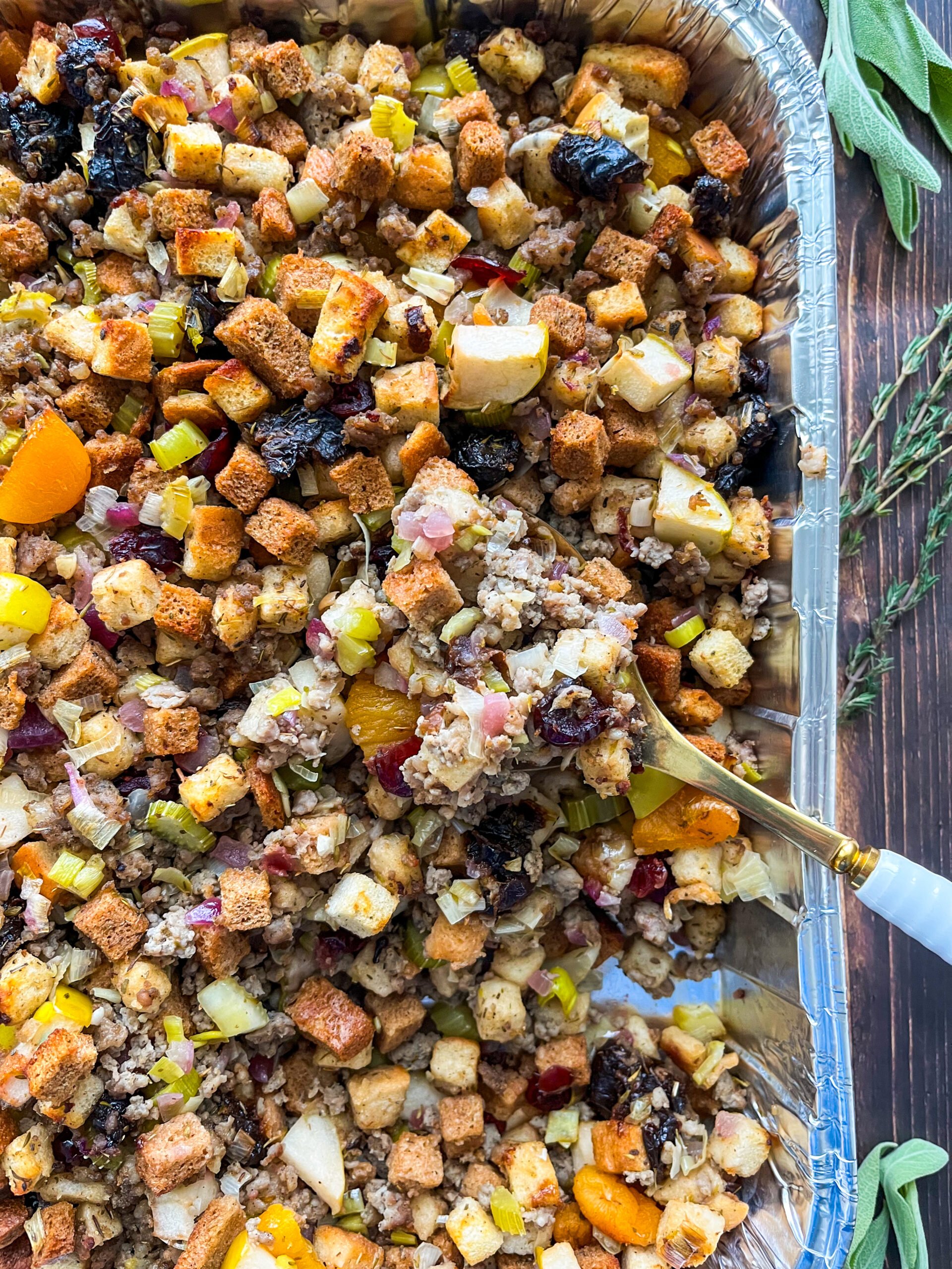 Scooping sausage stuffing with serving spoon
