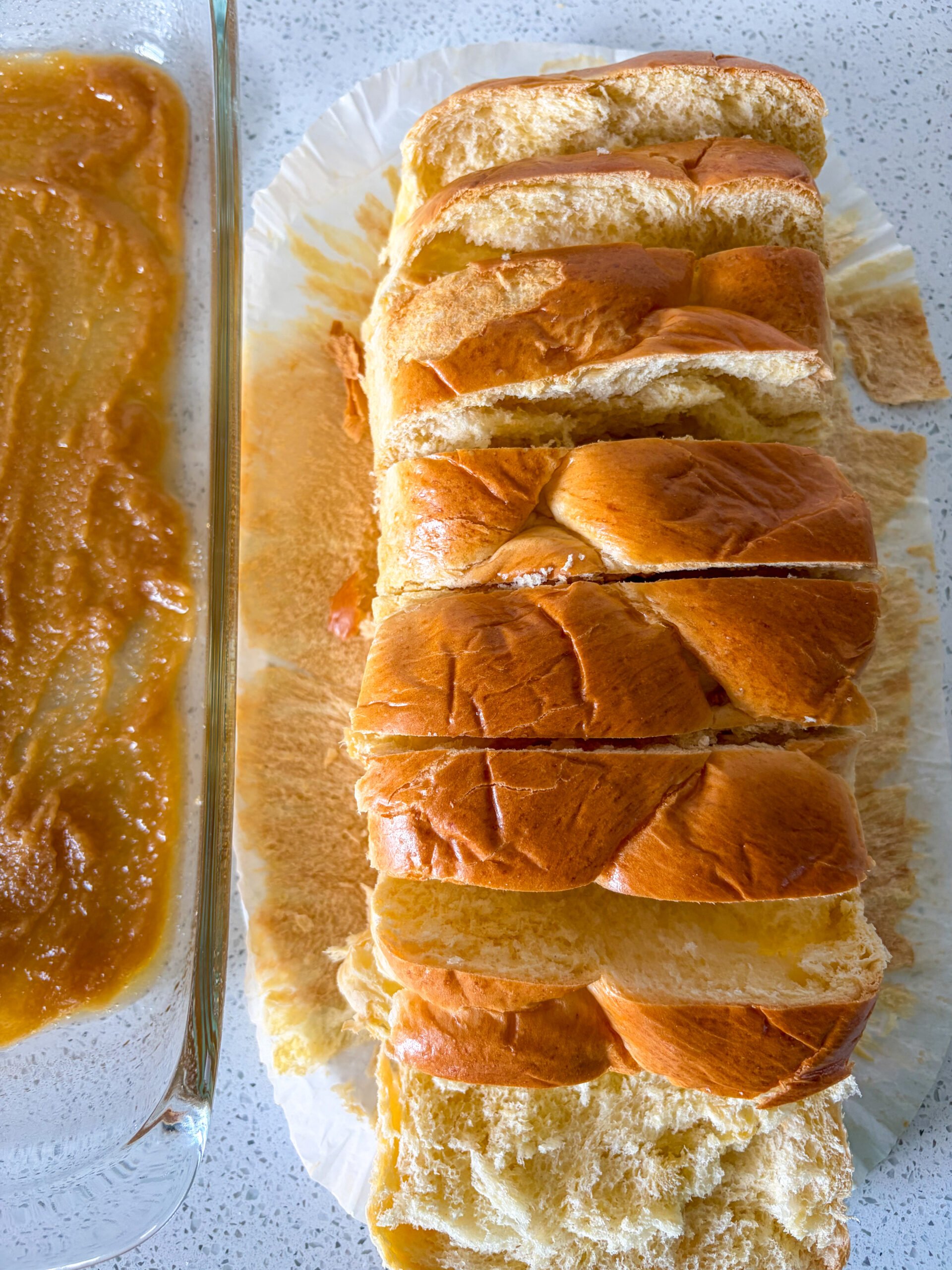 Brioche loaf sliced next to pan