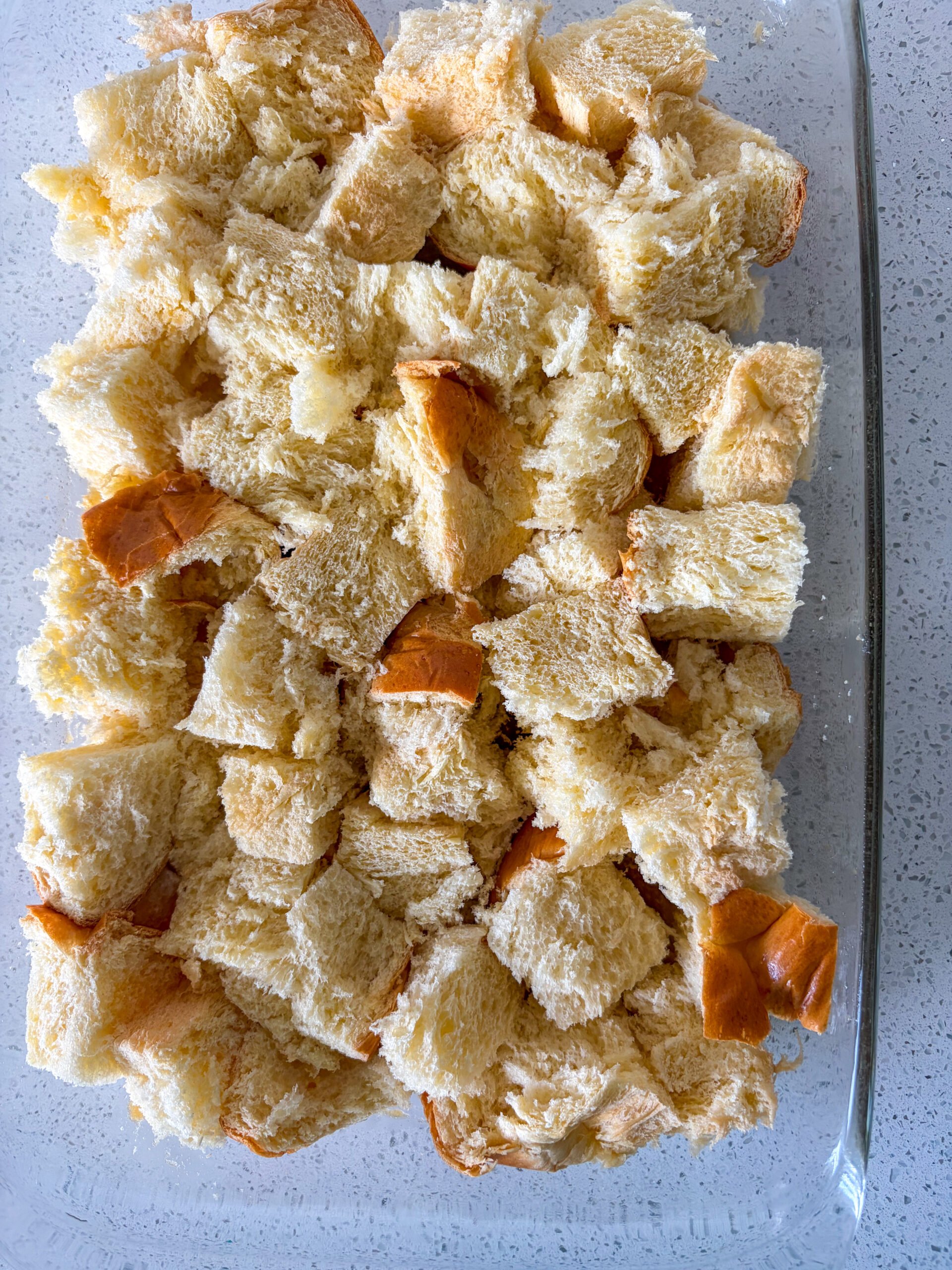 Cubed brioche in a single layer in pan