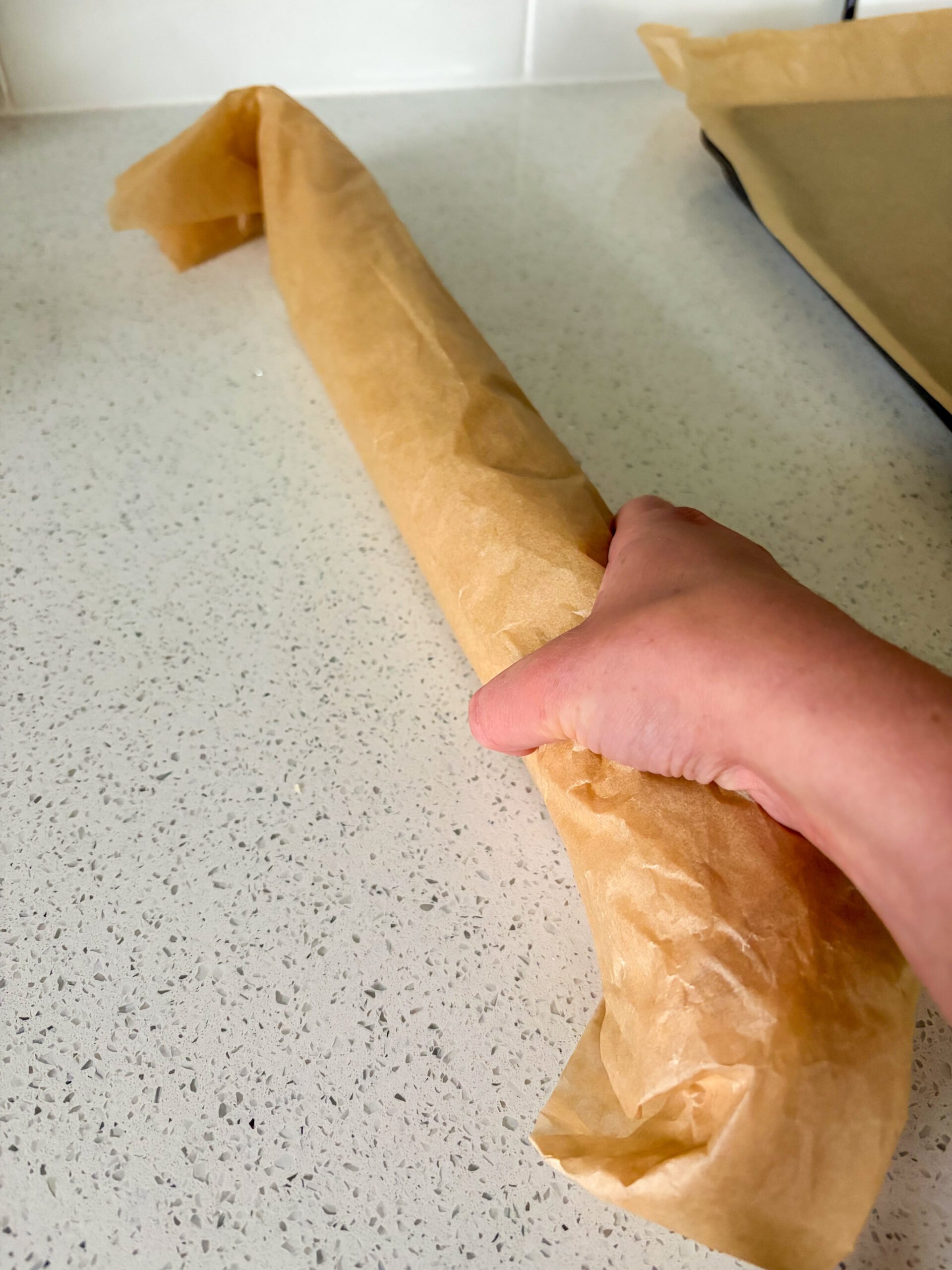 Rolling cookie dough in parchment paper