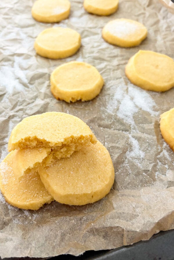 Butter cookies stacked and laid out on parchment