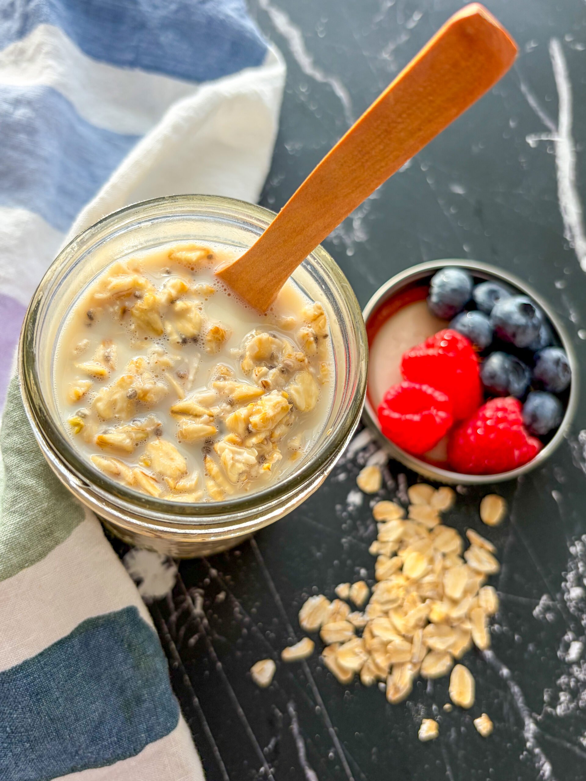 Overnight oats in a glass jar with wooden spoon