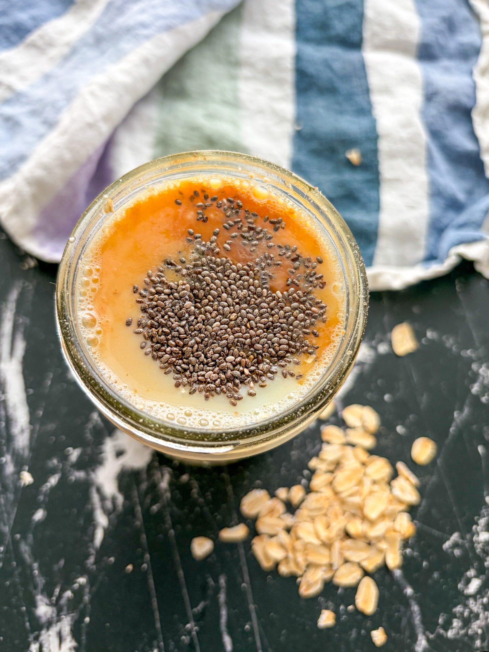 Overnight oat ingredients added to a jar before mixing