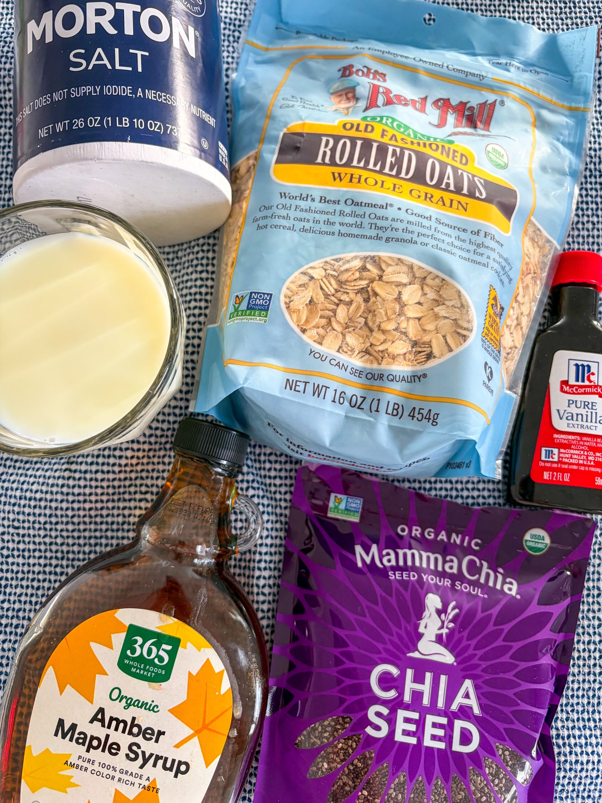 Overnight oats ingredients on a blue and white dish towel