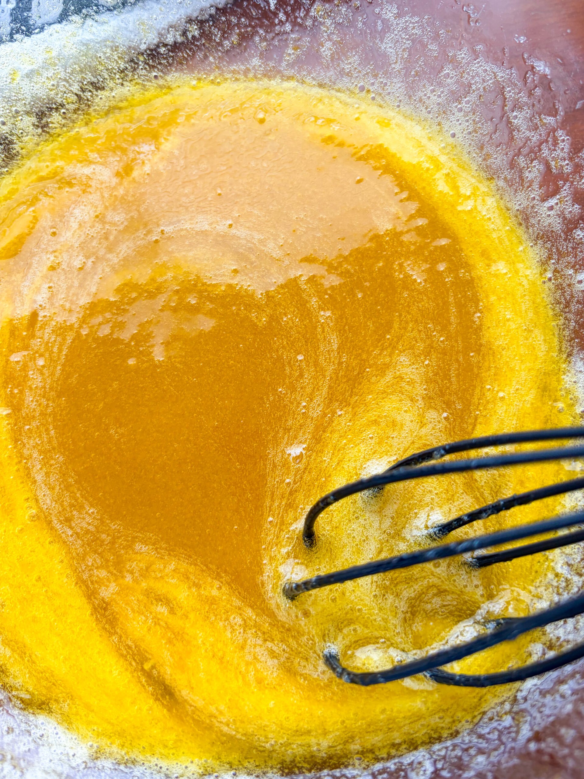 Vigorously whisked egg and sugar mixture in a glass bowl