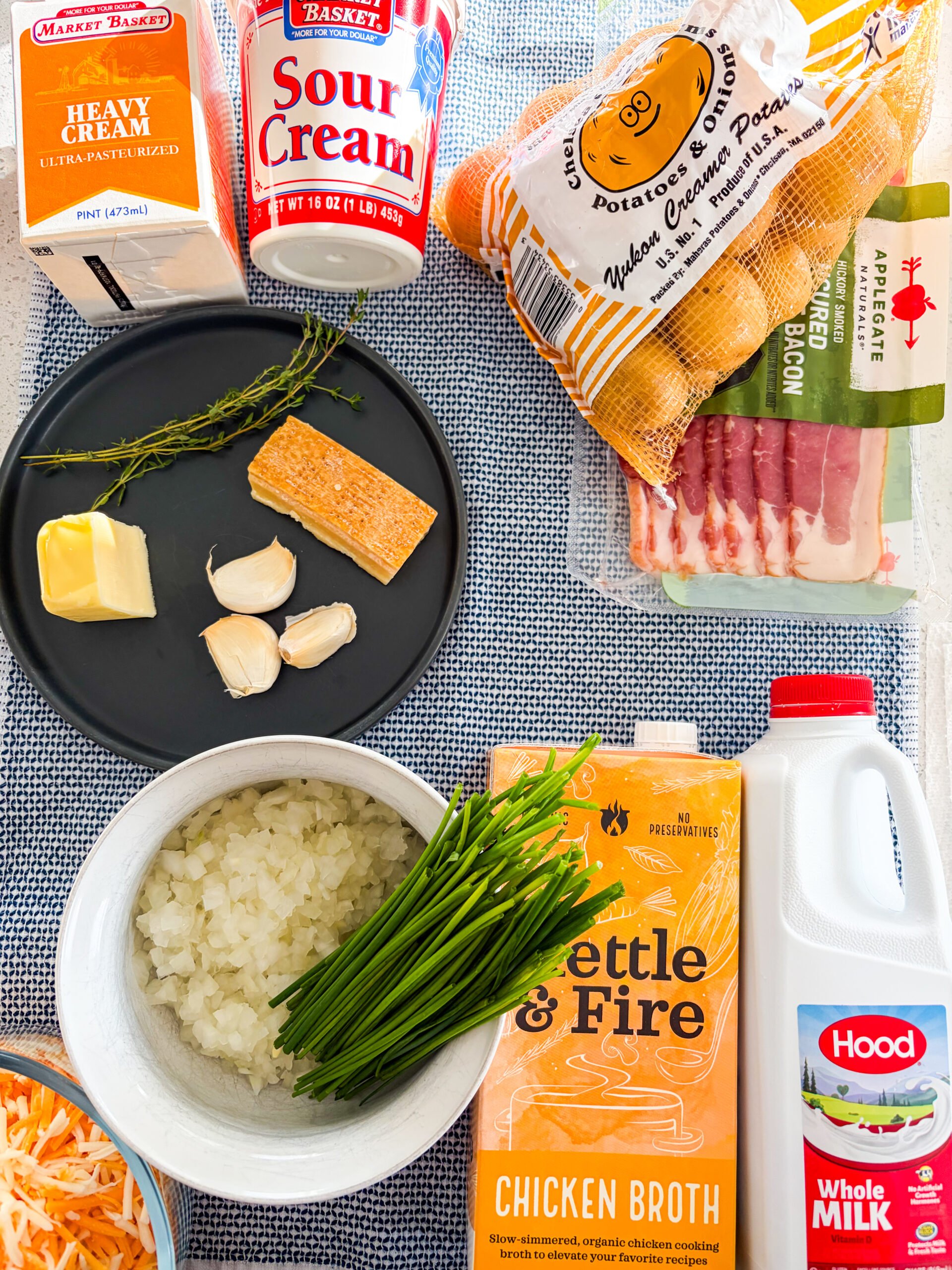 Potato soup recipe ingredients laid out on a blue and white dish towel