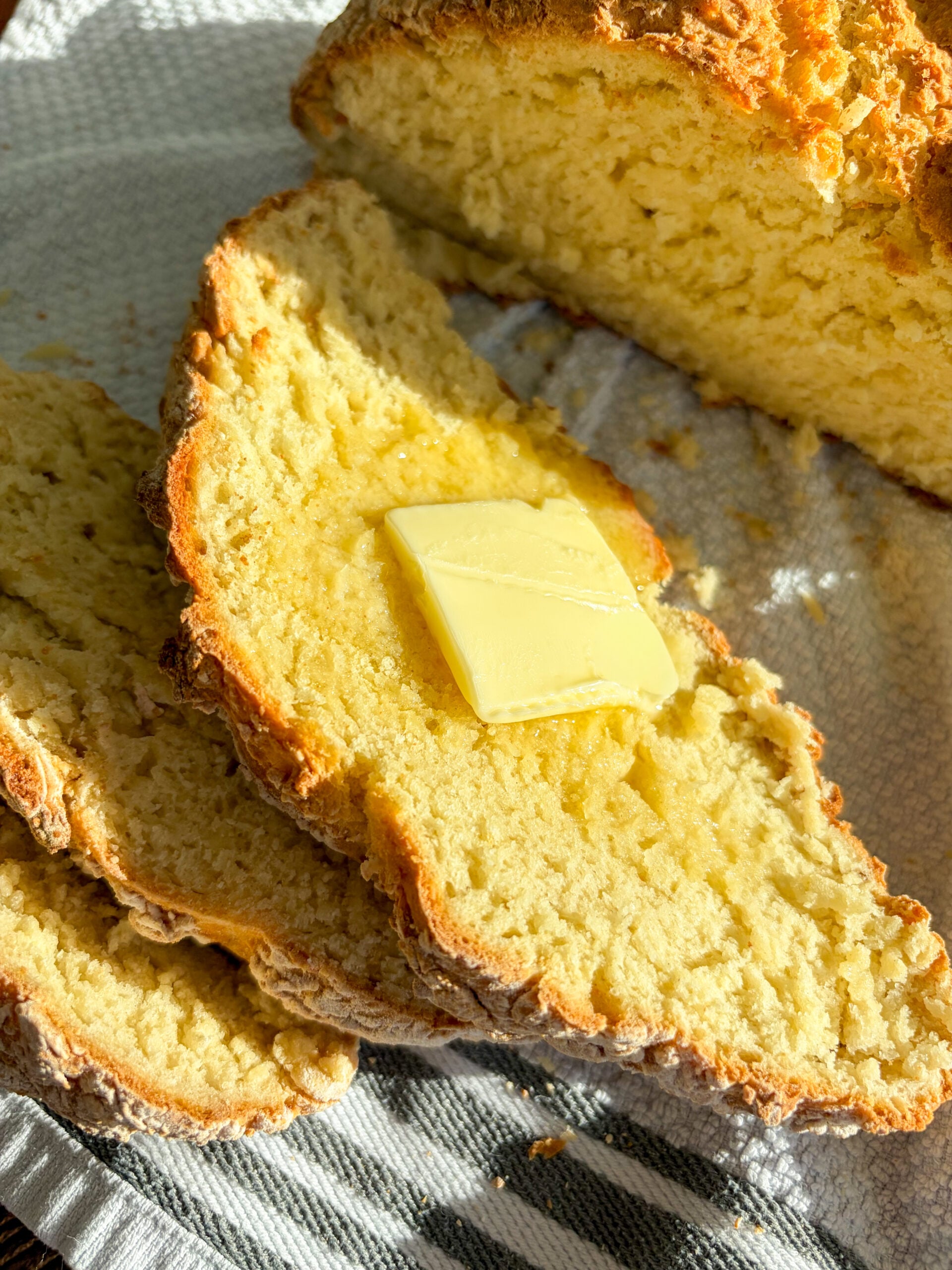 Close up of Irish soda bread sliced with butter