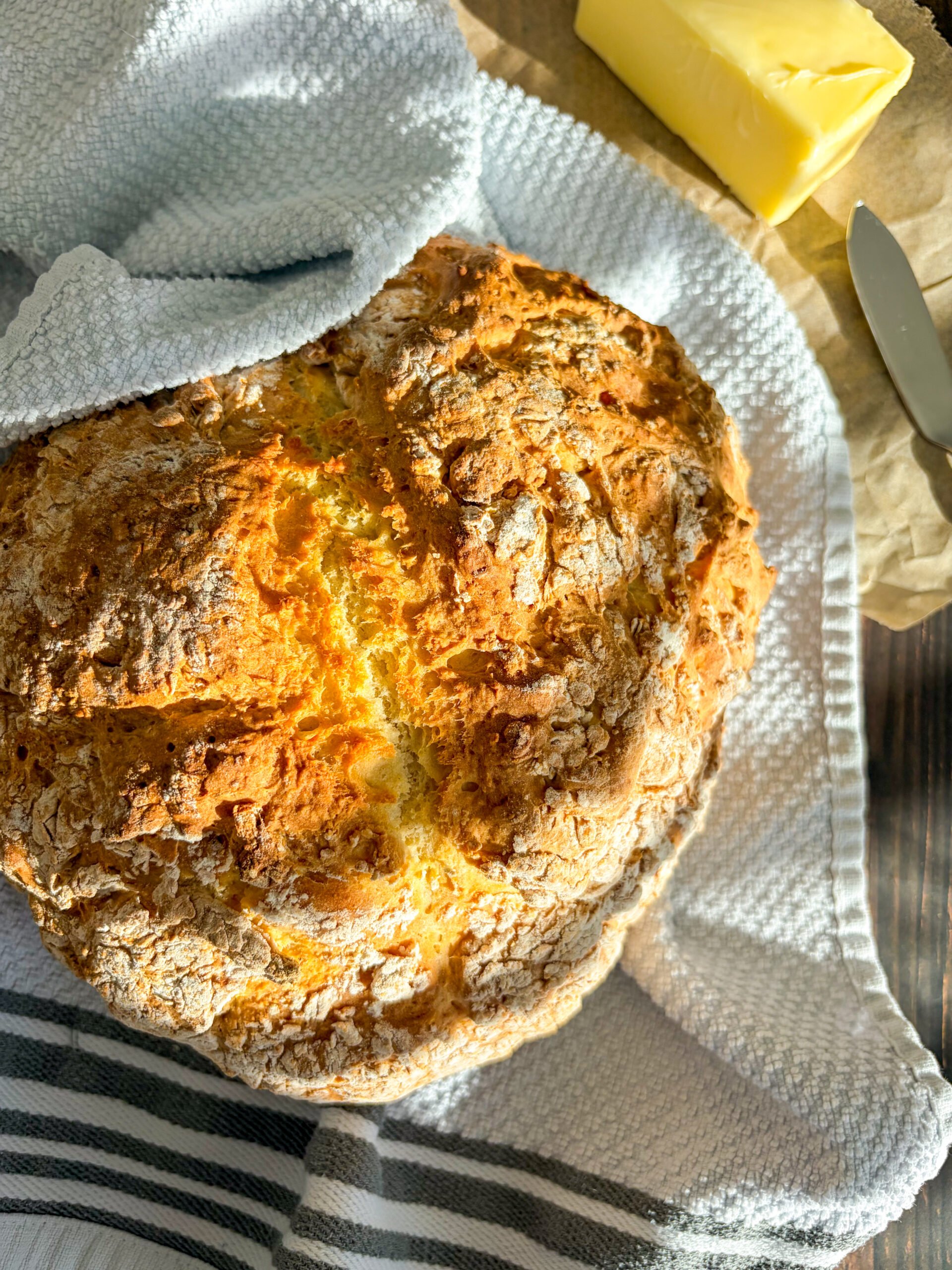 Irish soda bread loaf on white towel