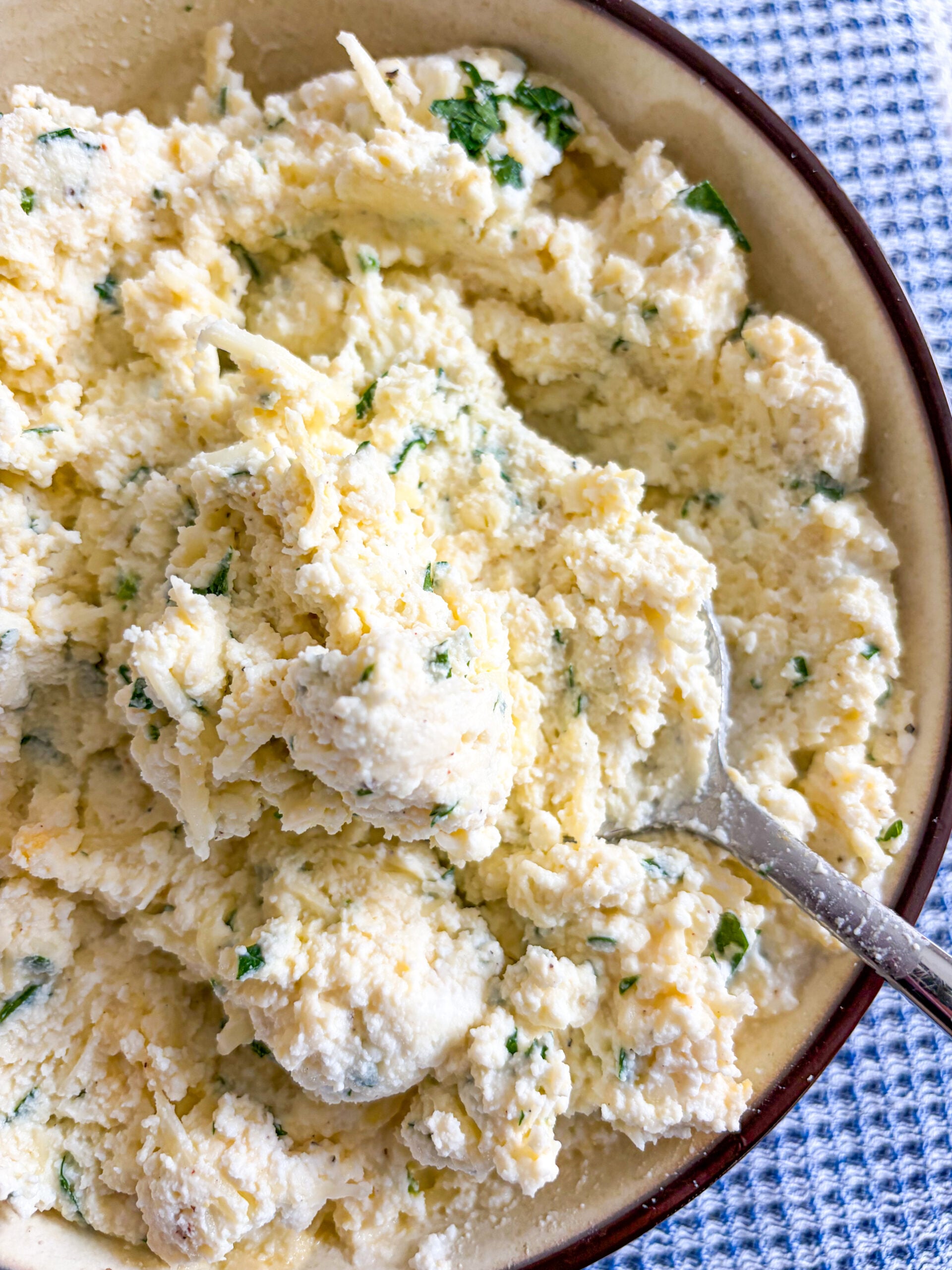 Ricotta filling mixture mixed together in bowl with spoon