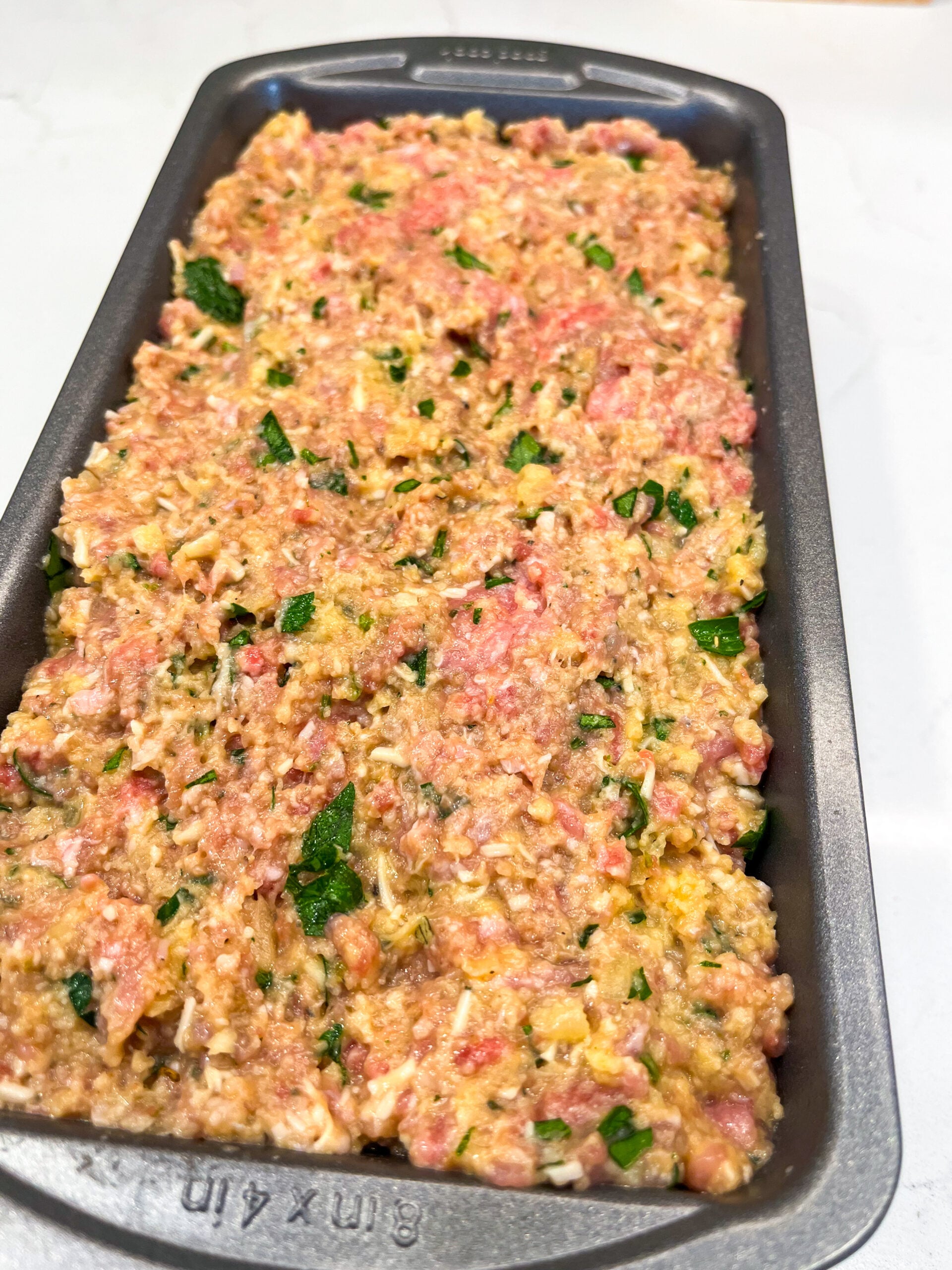 Meatloaf mixture spread in pan