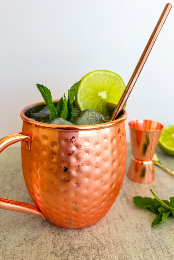 Moscow mule in a copper coper garnished with lime and mint