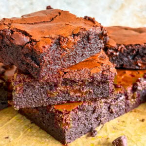 Brownie slices stacked close up on parchment