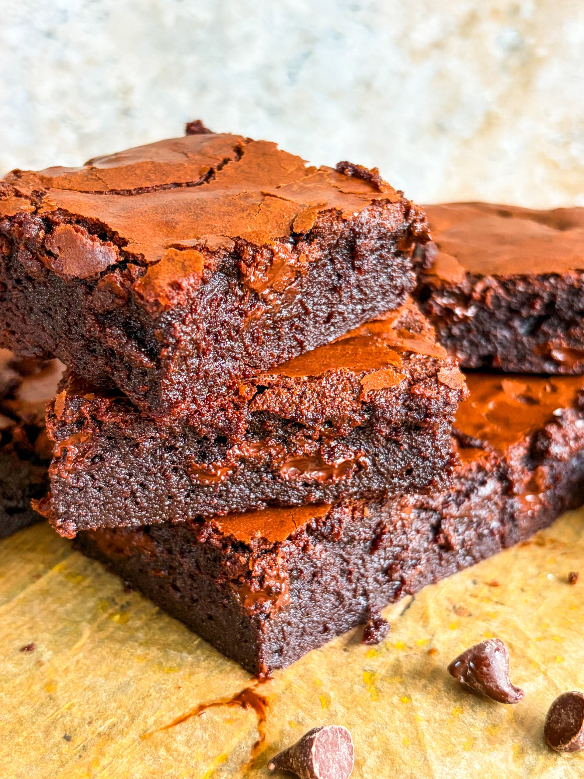 Brownie slices stacked close up on parchment