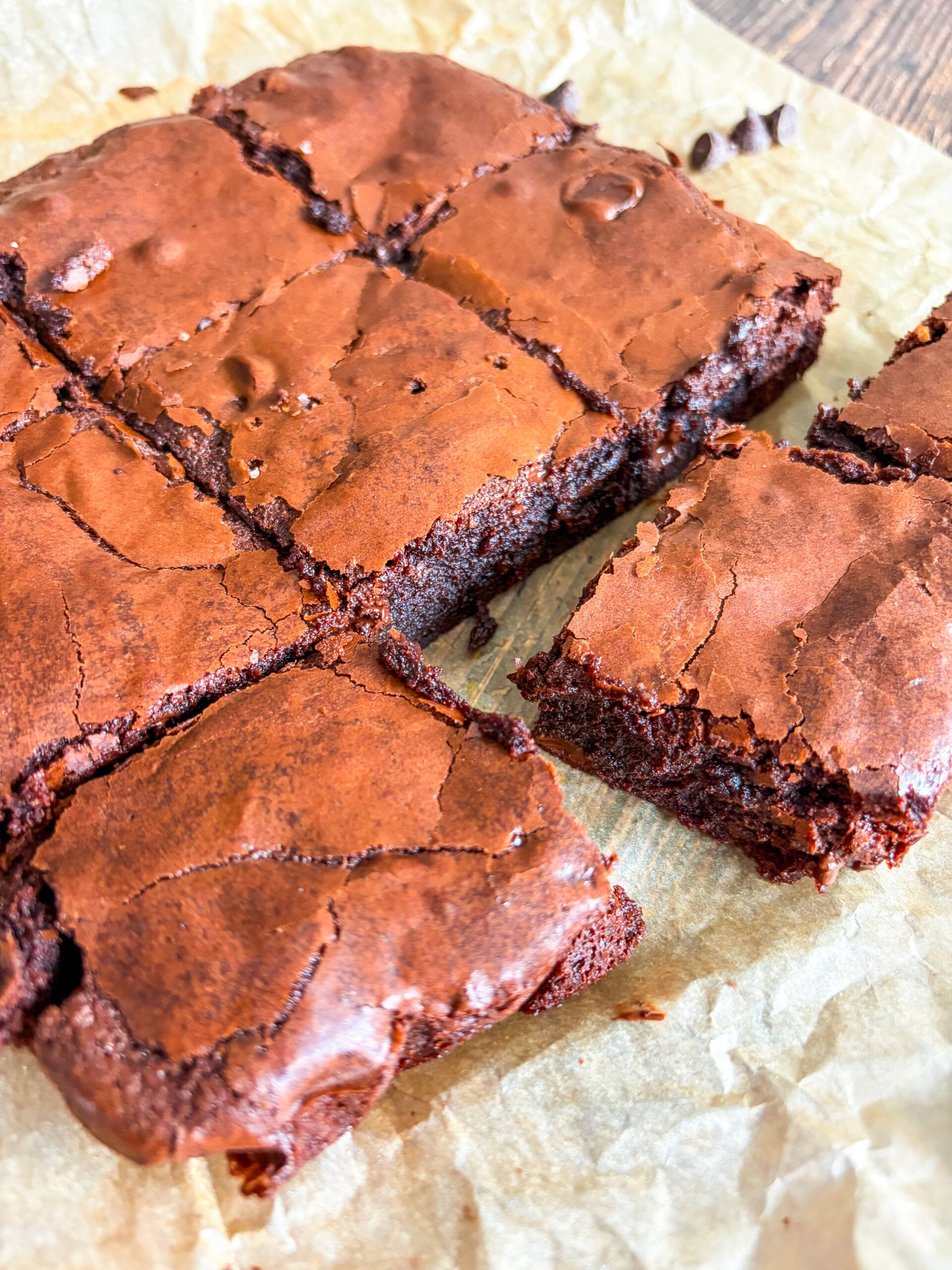 Cut brownies laid out on parchment close up