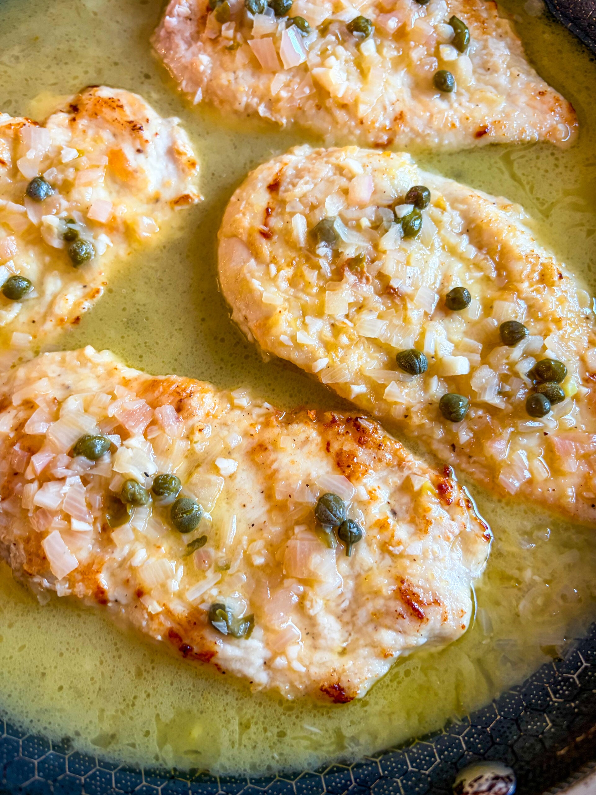Close up of chicken piccata in pan