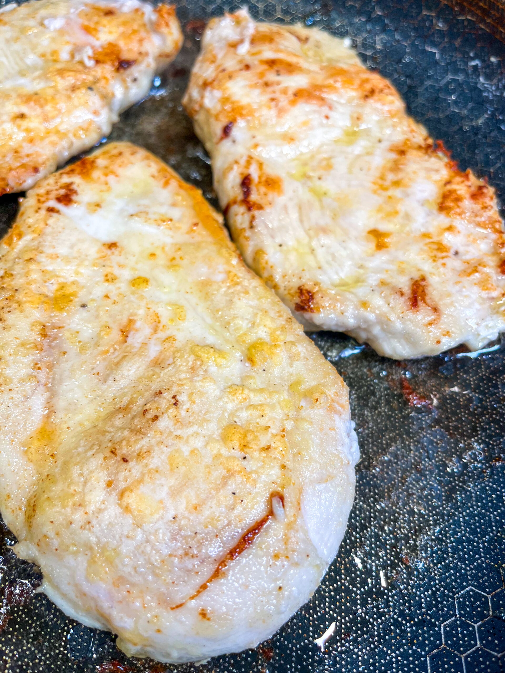 Pan searing chicken cutlets in pan
