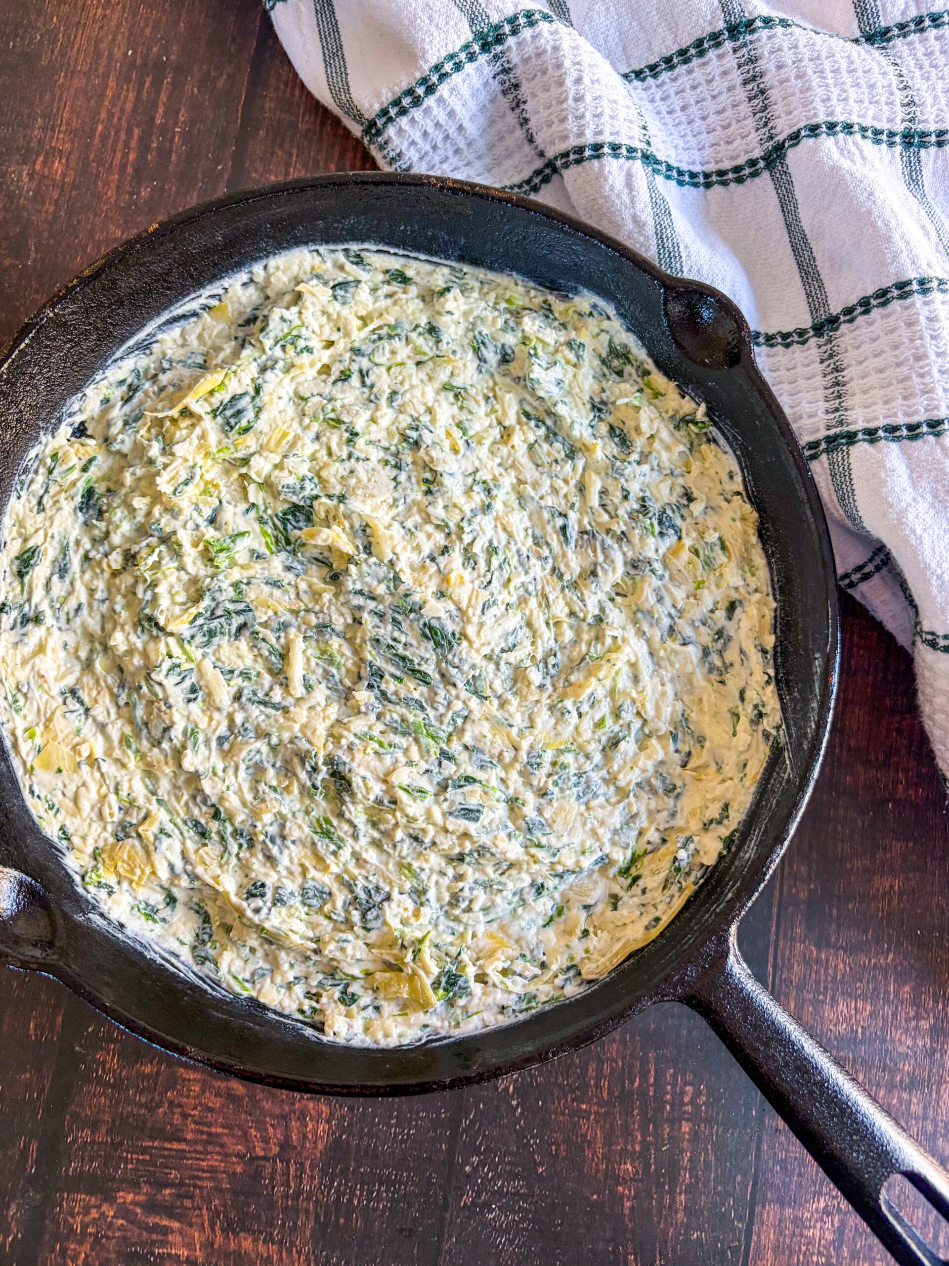 Spinach artichoke dip spread in black skillet
