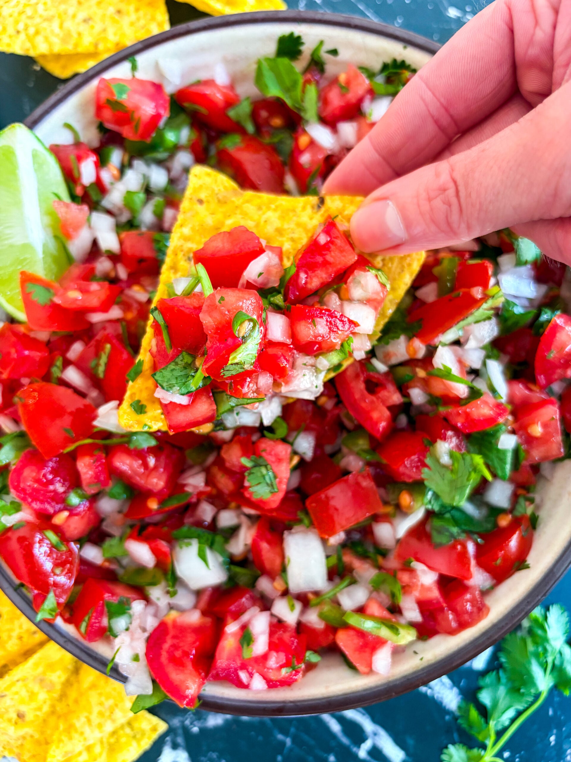 Close up of scooping pico on a tortilla chip