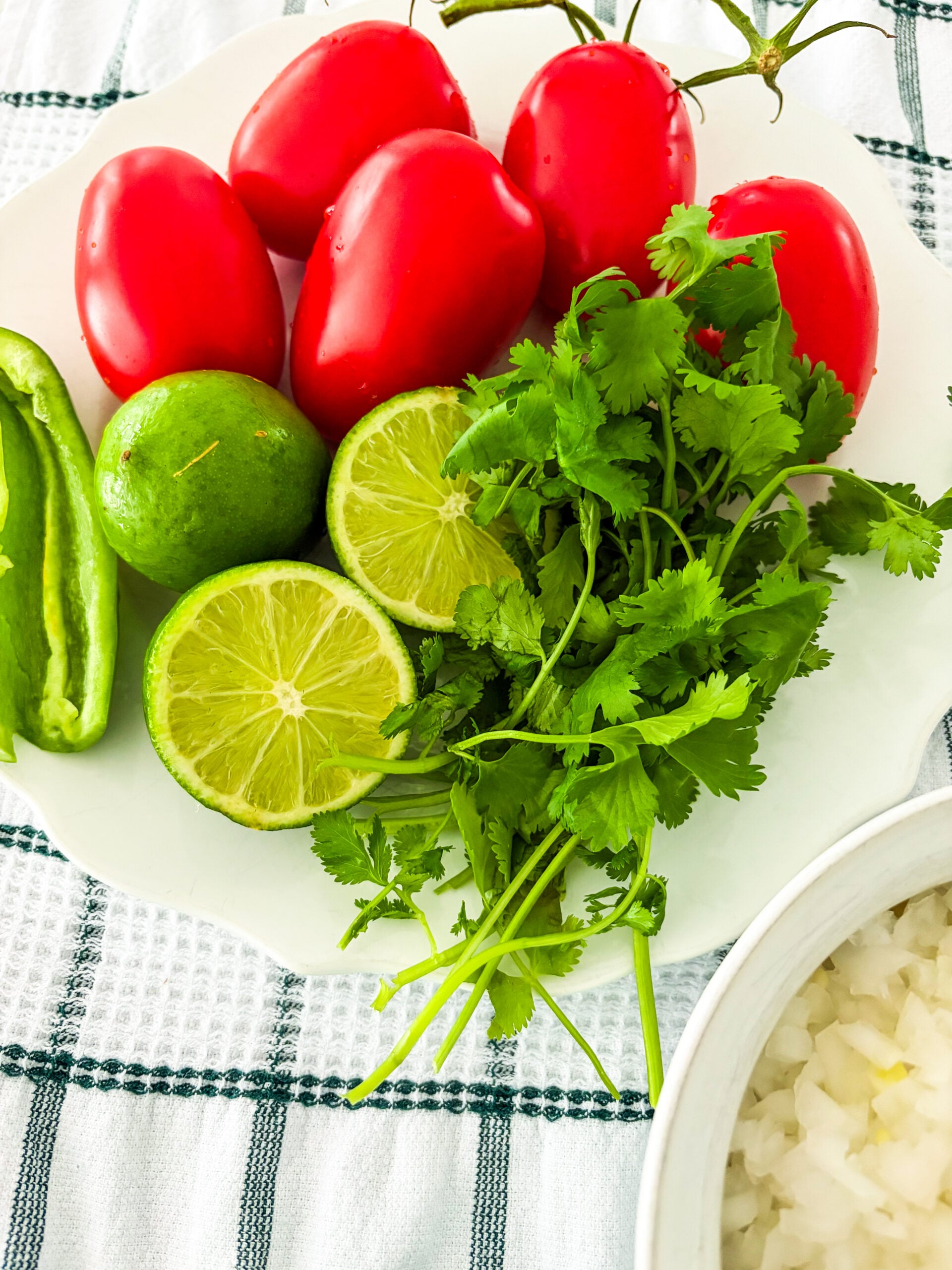 Pico de gallo ingredients laid out on a dish towel