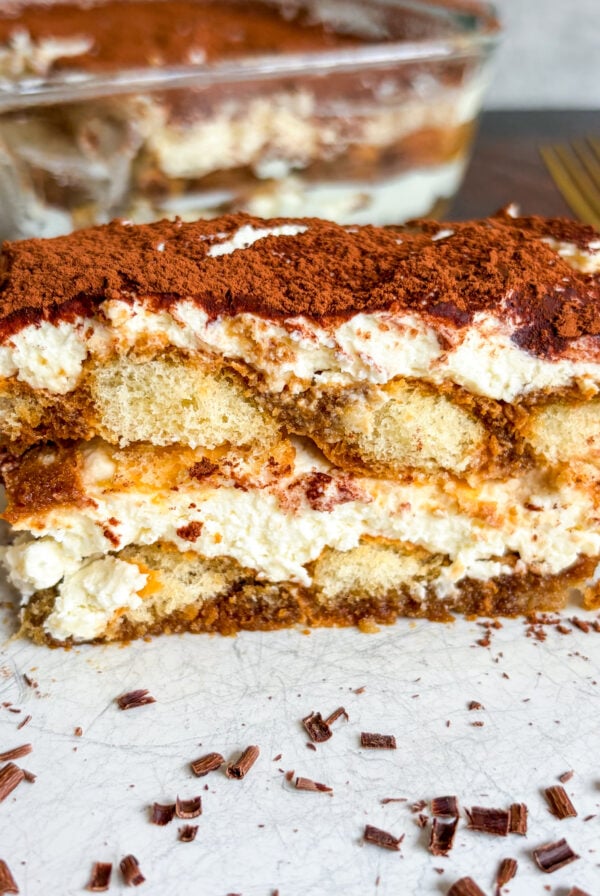 Close up of tiramisu slice on white plate
