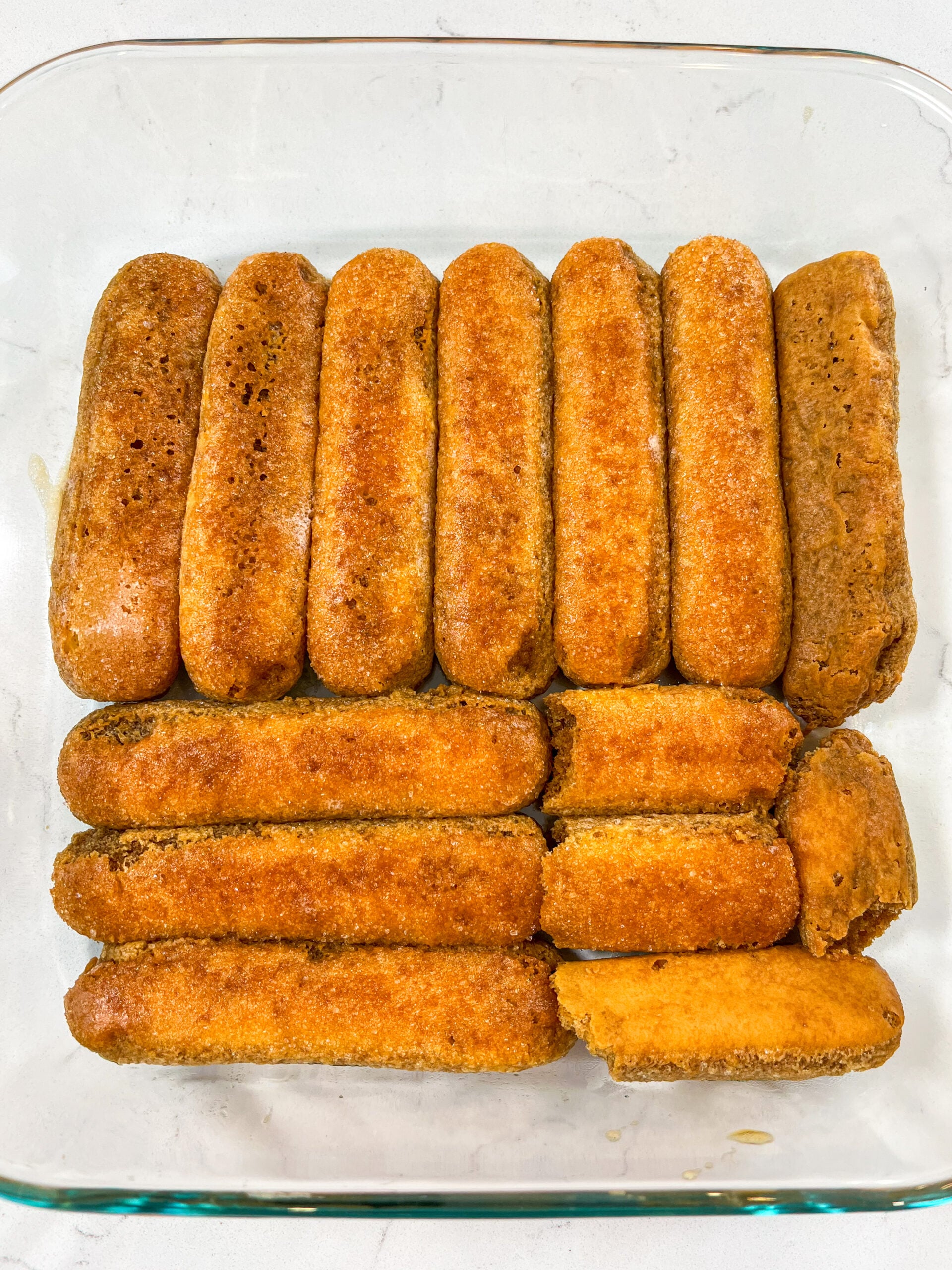 Dipped ladyfingers in single layer in glass baking pan