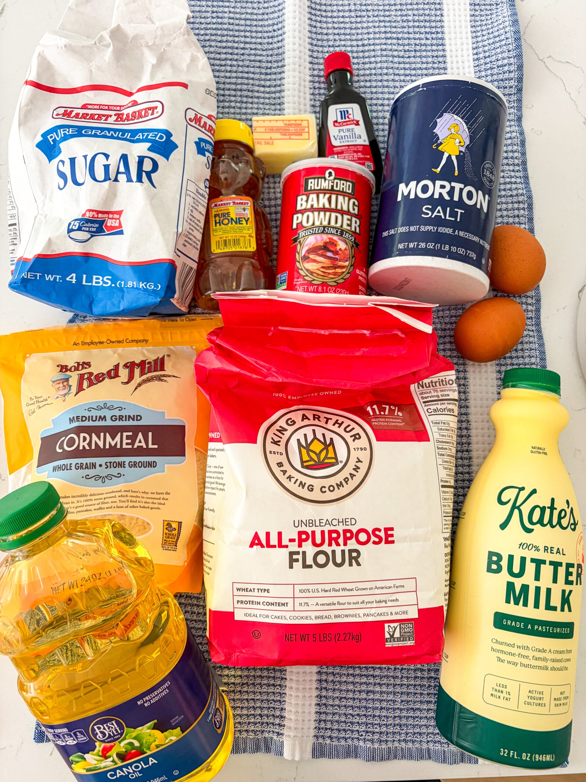 Cornbread ingredients laid out on a blue and white dish towel