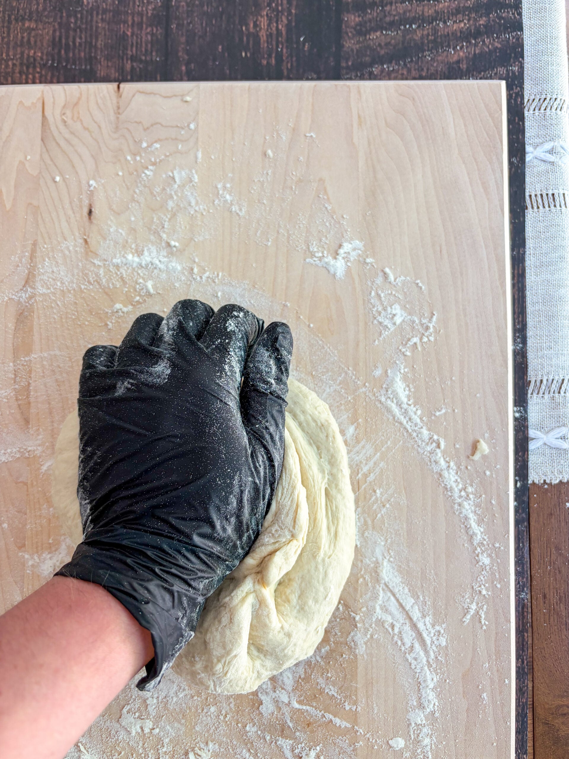 Dough being kneaded on floured cutting board