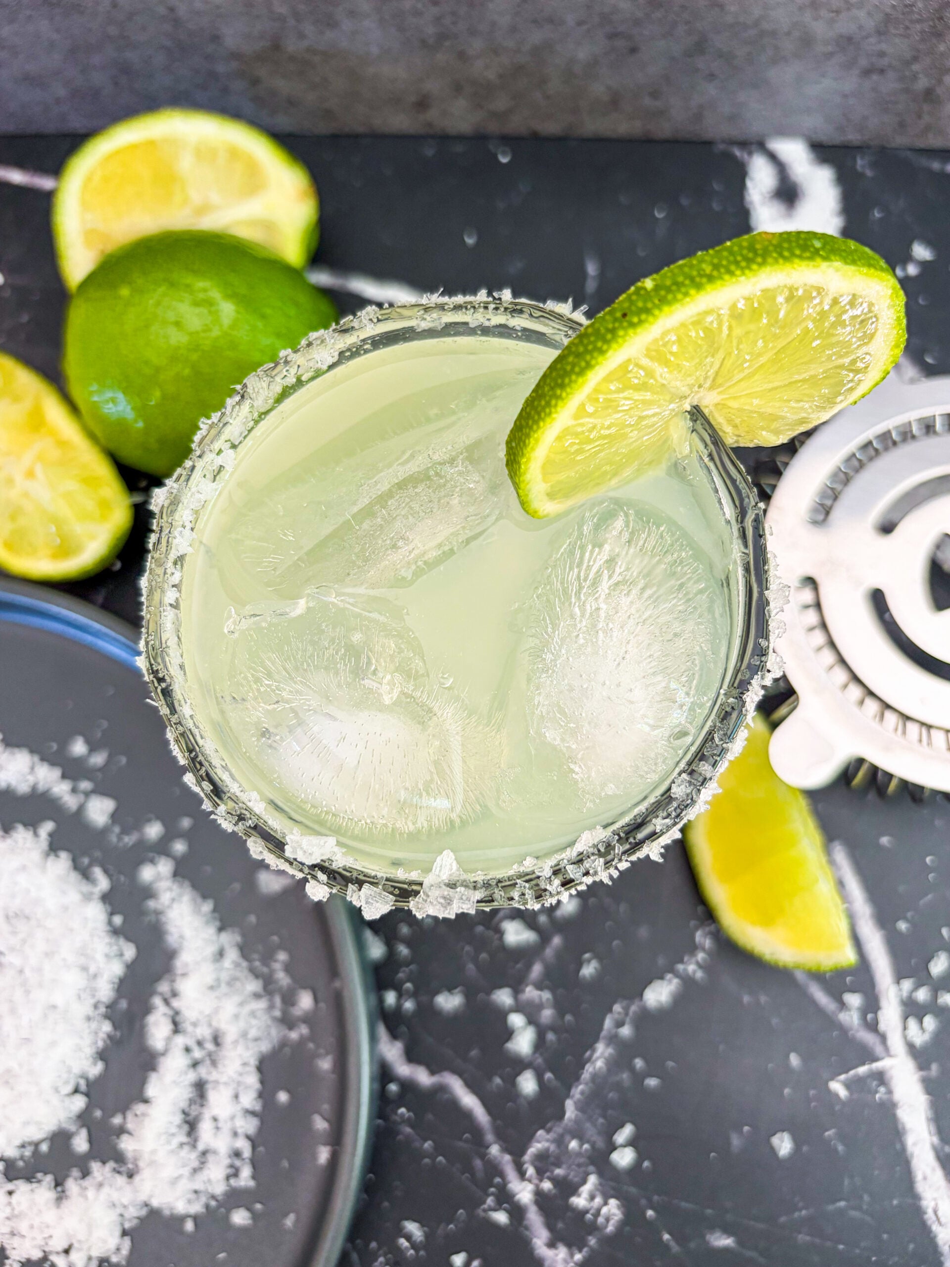 Overhead shot of margarita garnished with lime wheel