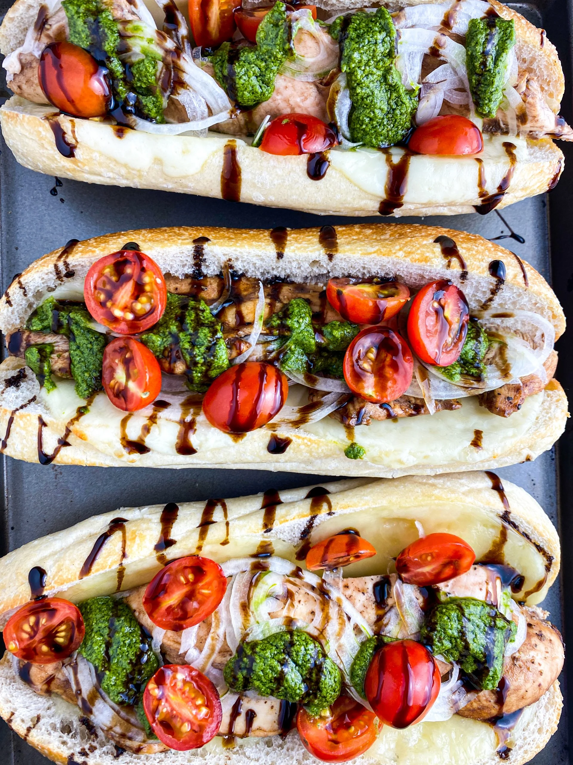 Pesto chicken sub sandwiches on a tray