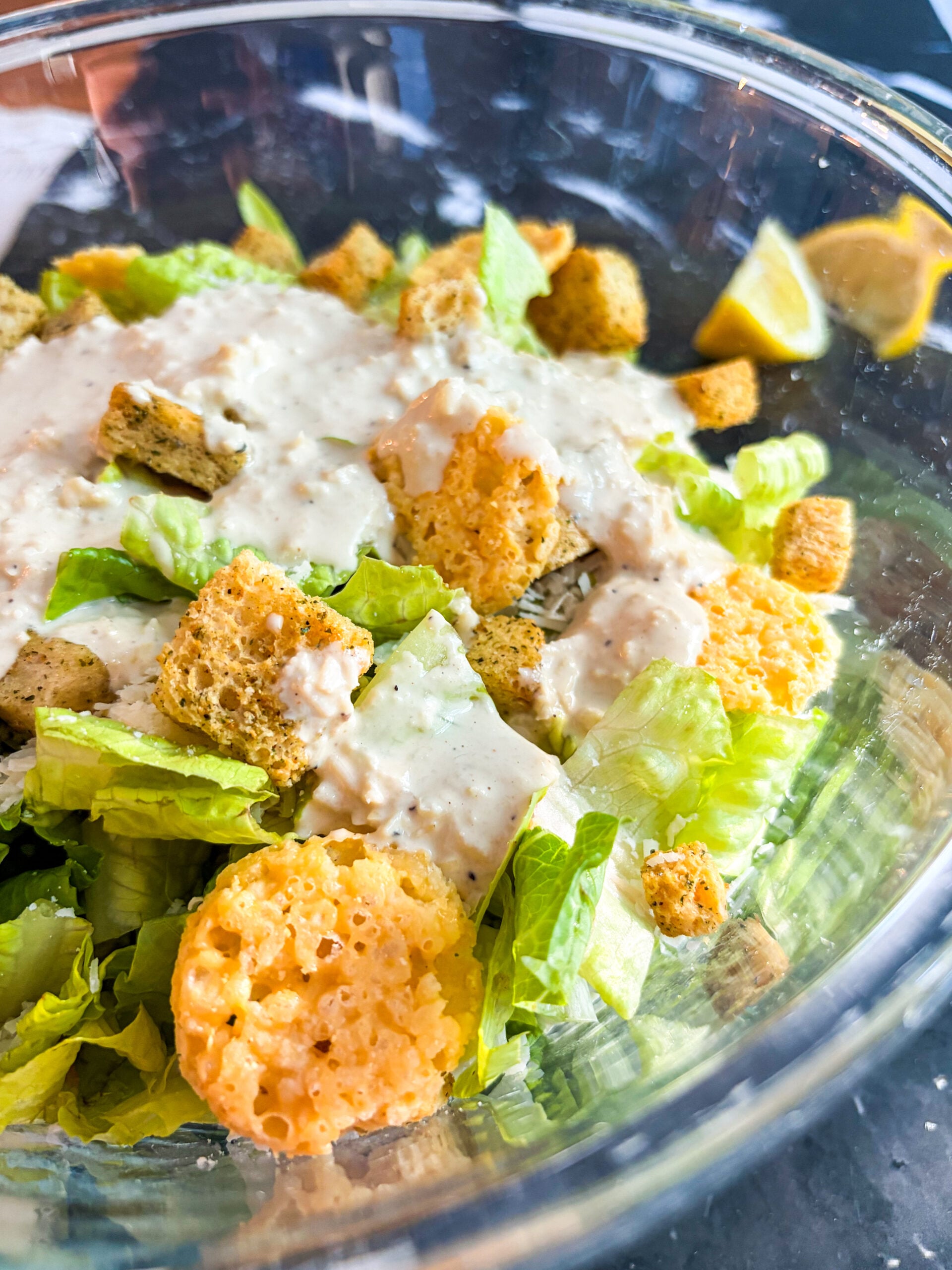 Close up of Caesar salad with dressing drizzle on top