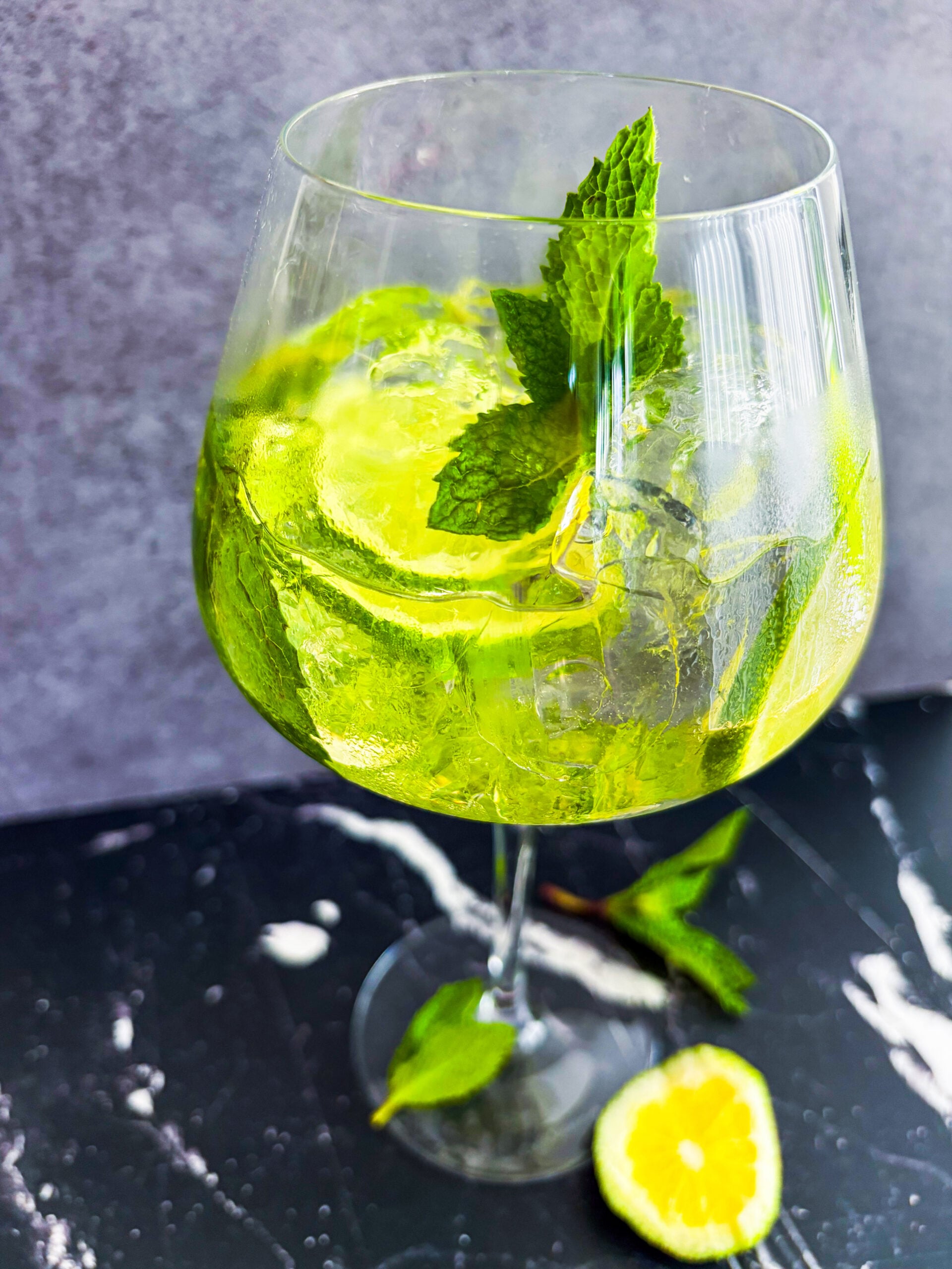 Close up of Hugo Spritz in a wine glass garnished with mint