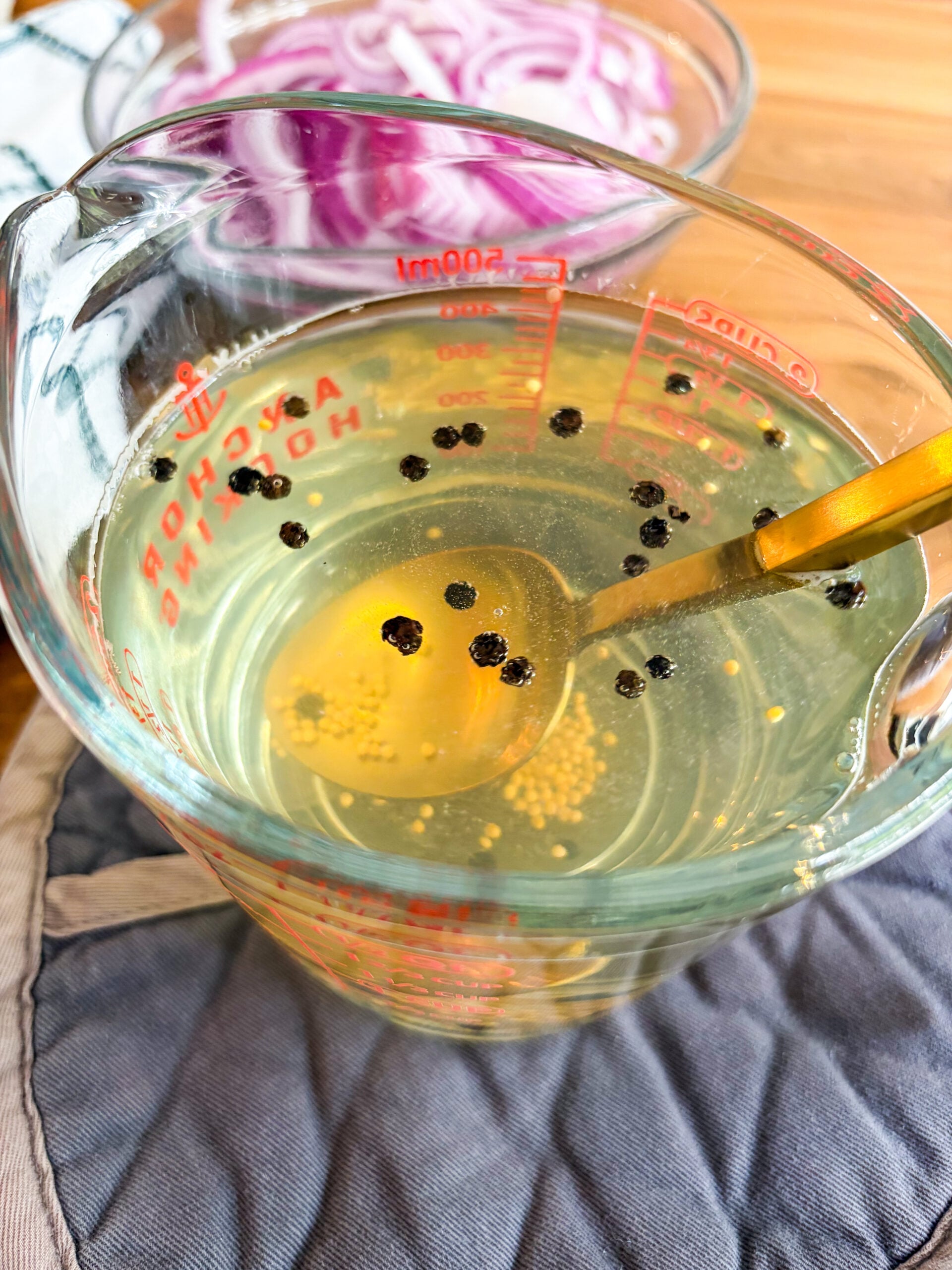 Pickling solution for red onions being stirred