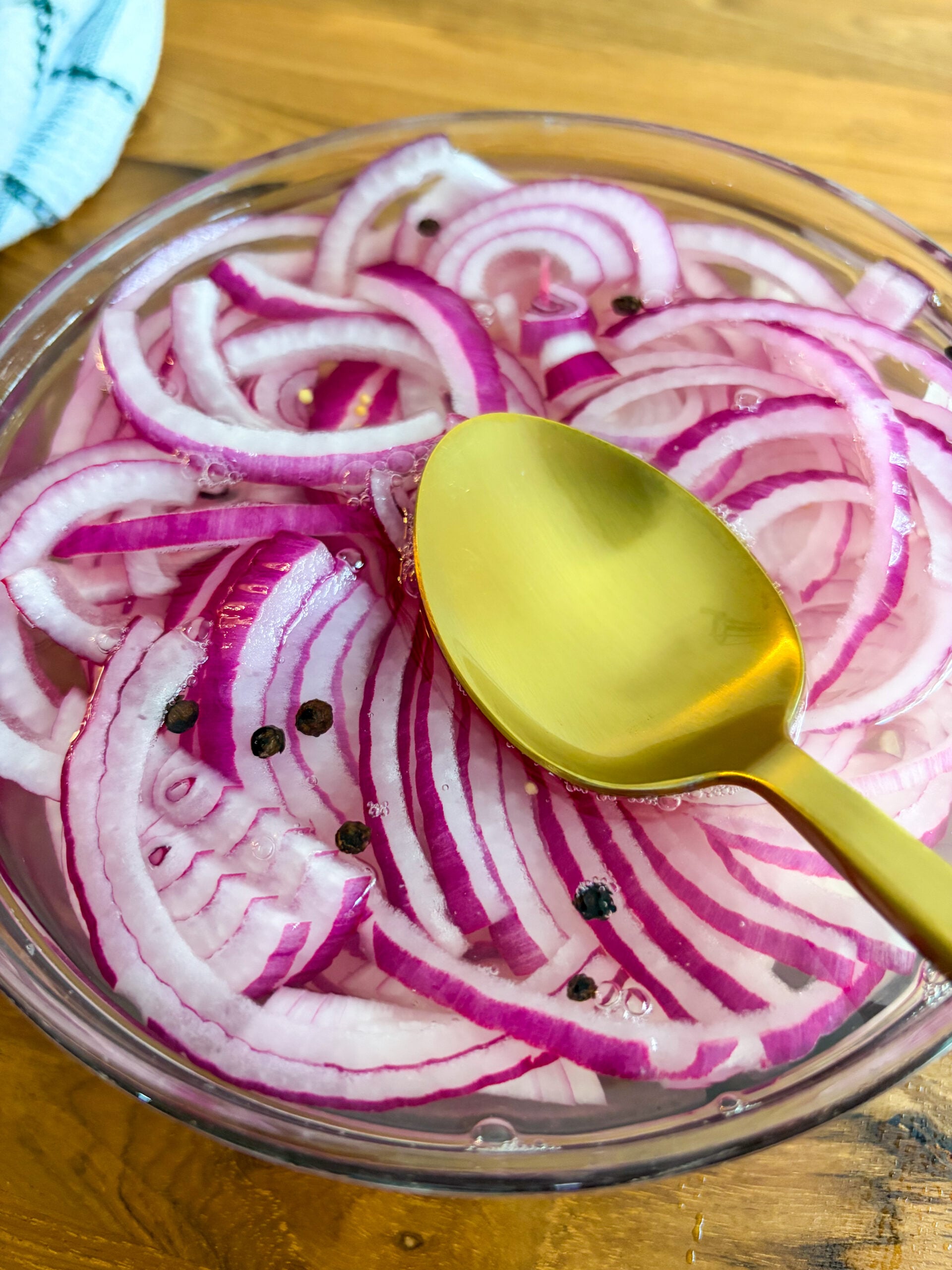 Adding and submerging onions to pickling solution