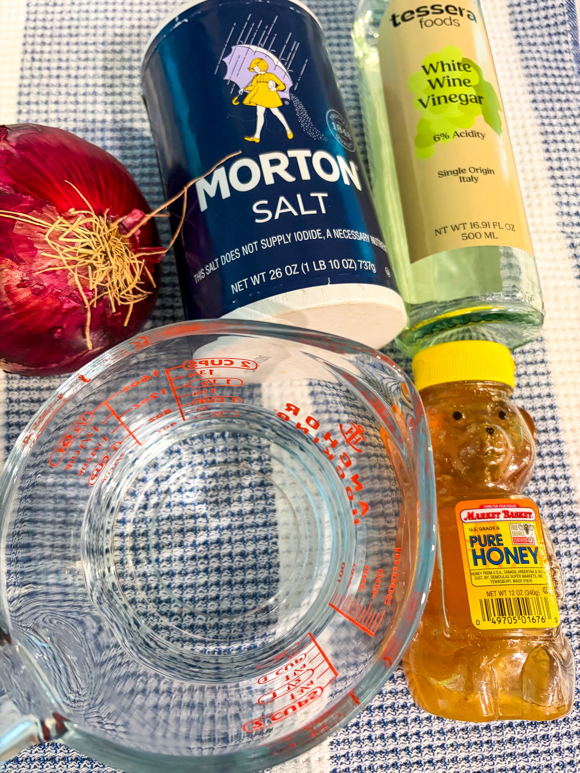 Pickled red onion ingredients laid out on a dish towel