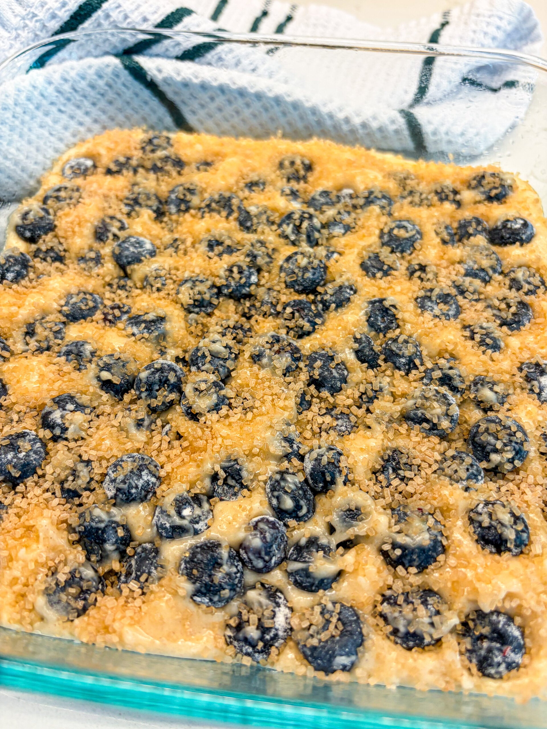 Turbinado sugar sprinkled on unbaked blueberry cobbler
