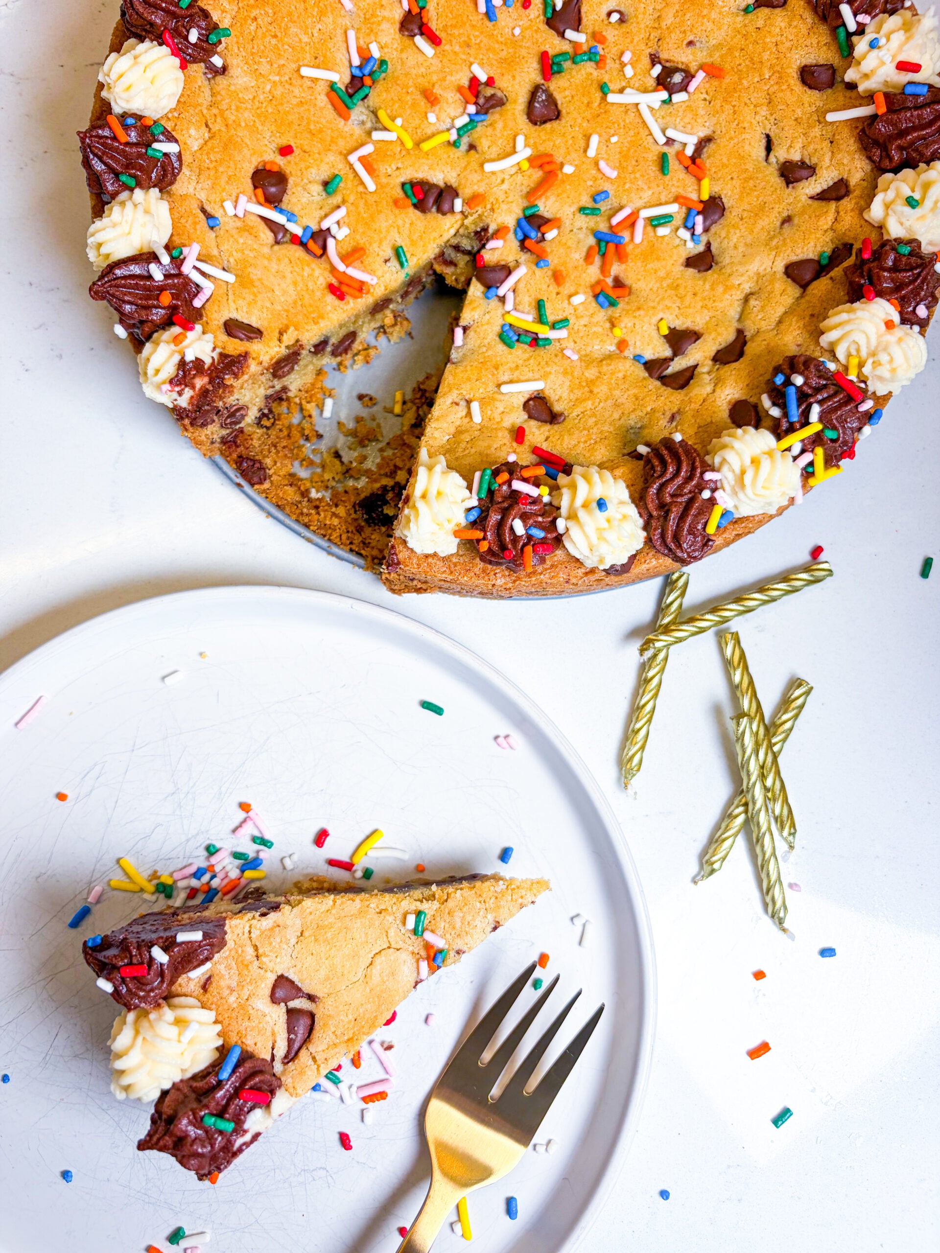 Slice on a plate next to full cookie cake