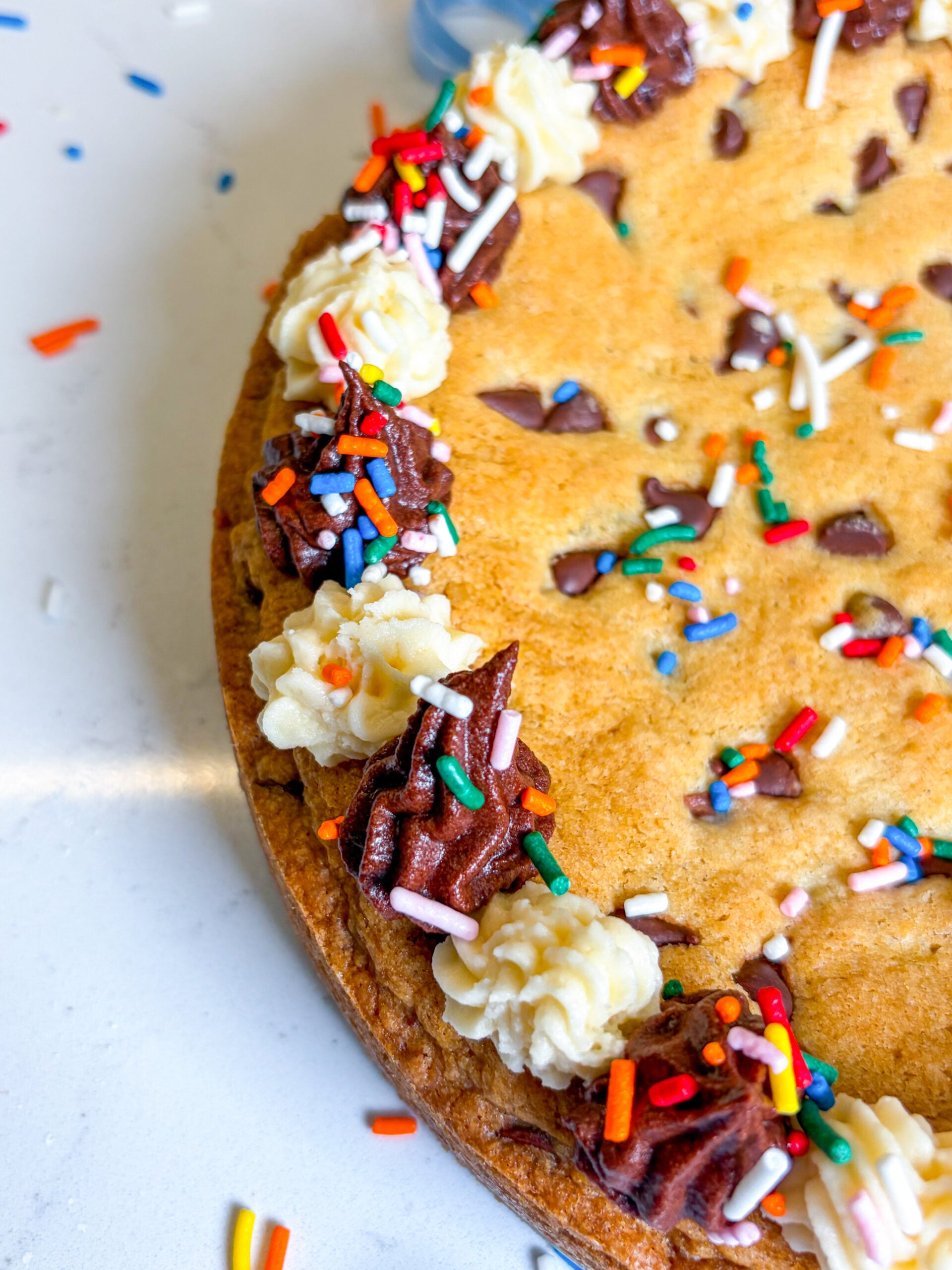 Close up of cookie cake with frosting and sprinkles