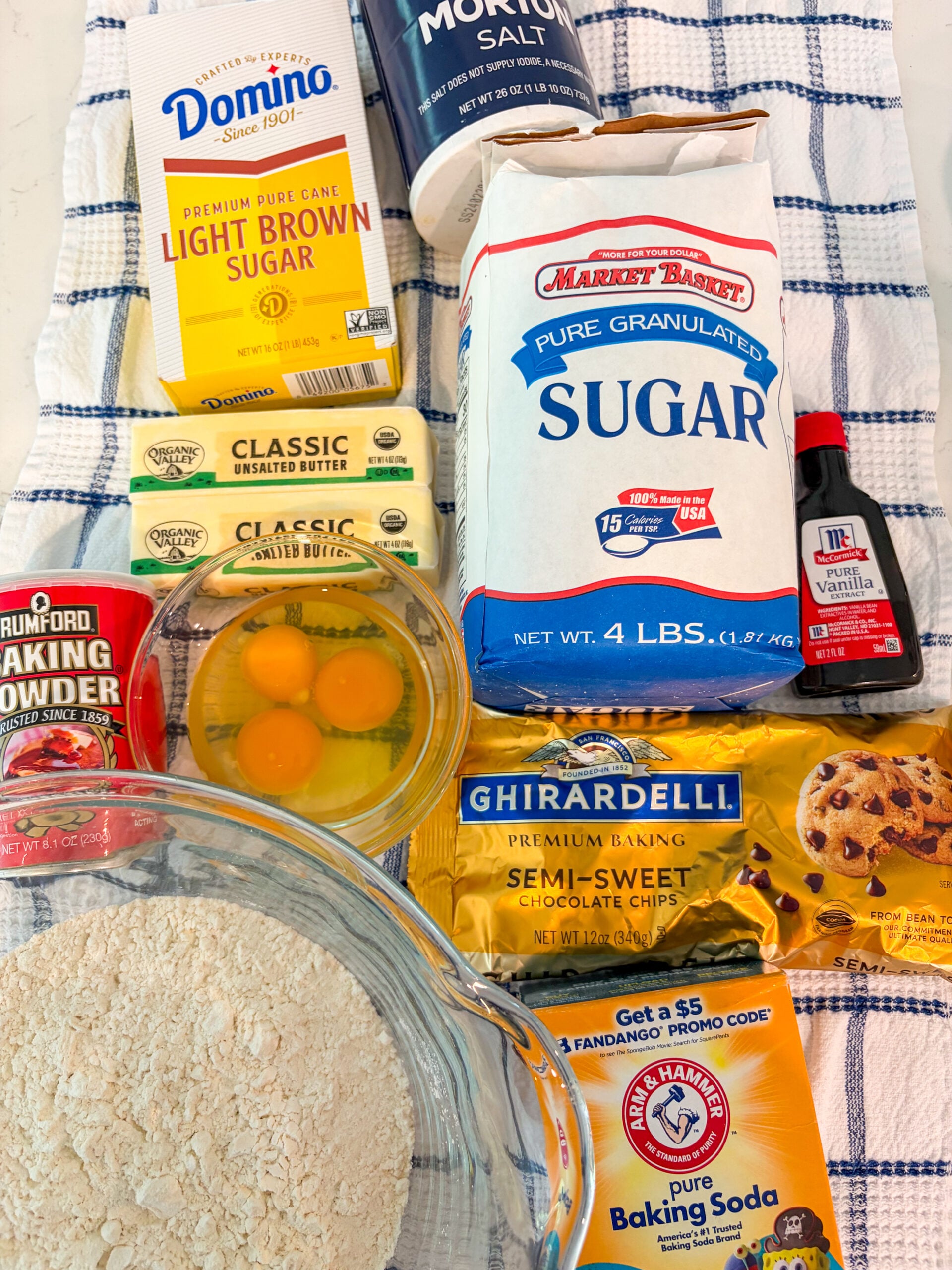 Cookie cake ingredients on a blue and white dish towel